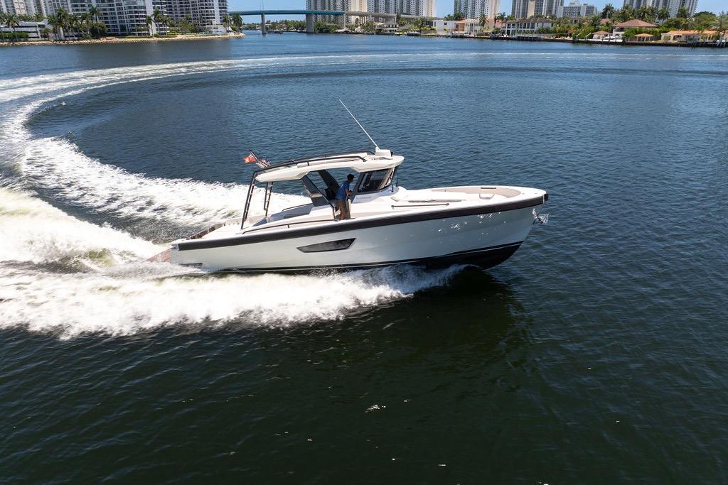 2021 Bluegame BG 42 yacht cruising on open water, creating a dynamic wake.
