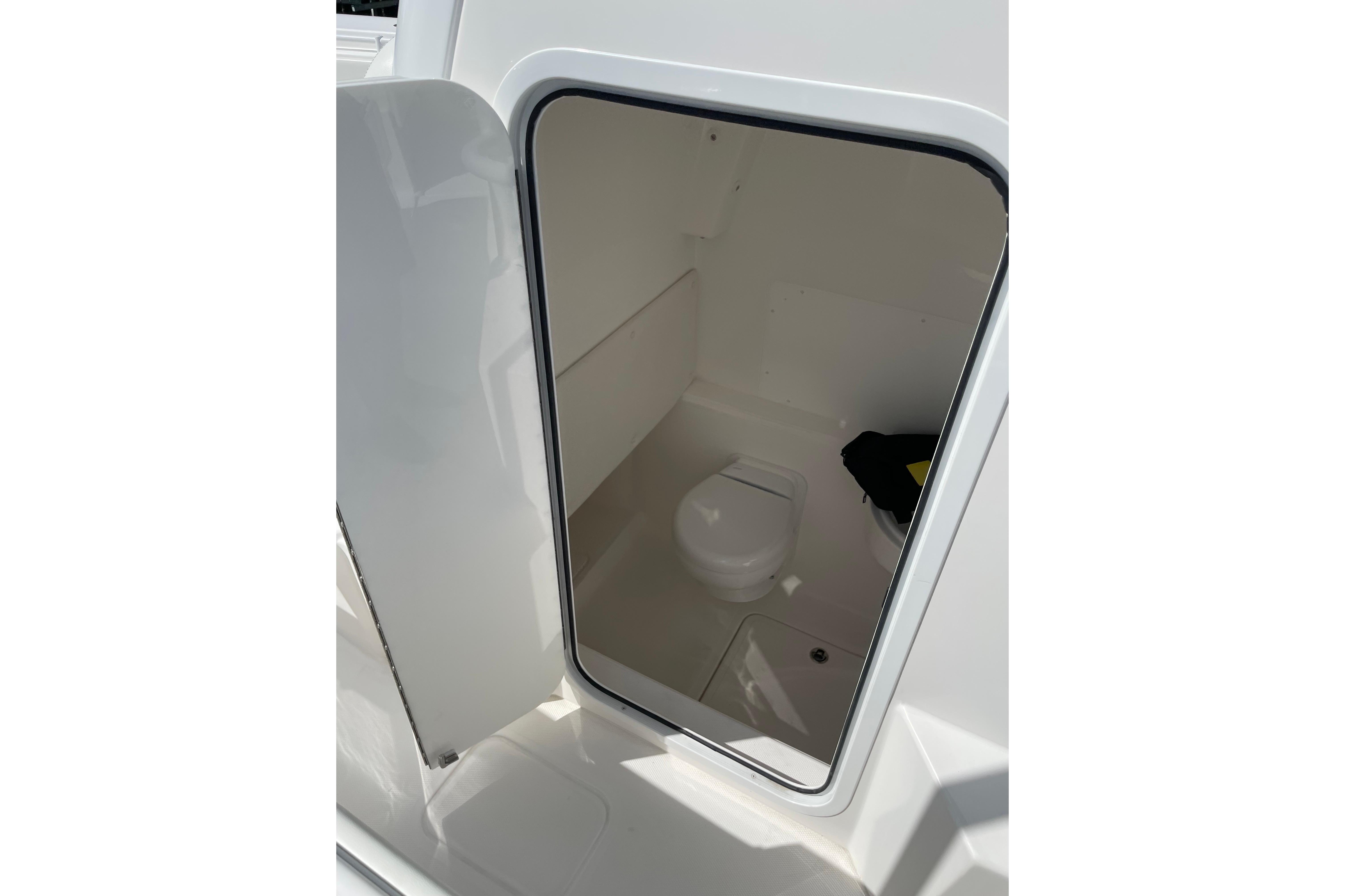 2024 Invincible 36 Open Fisherman boat interior with compact marine toilet.