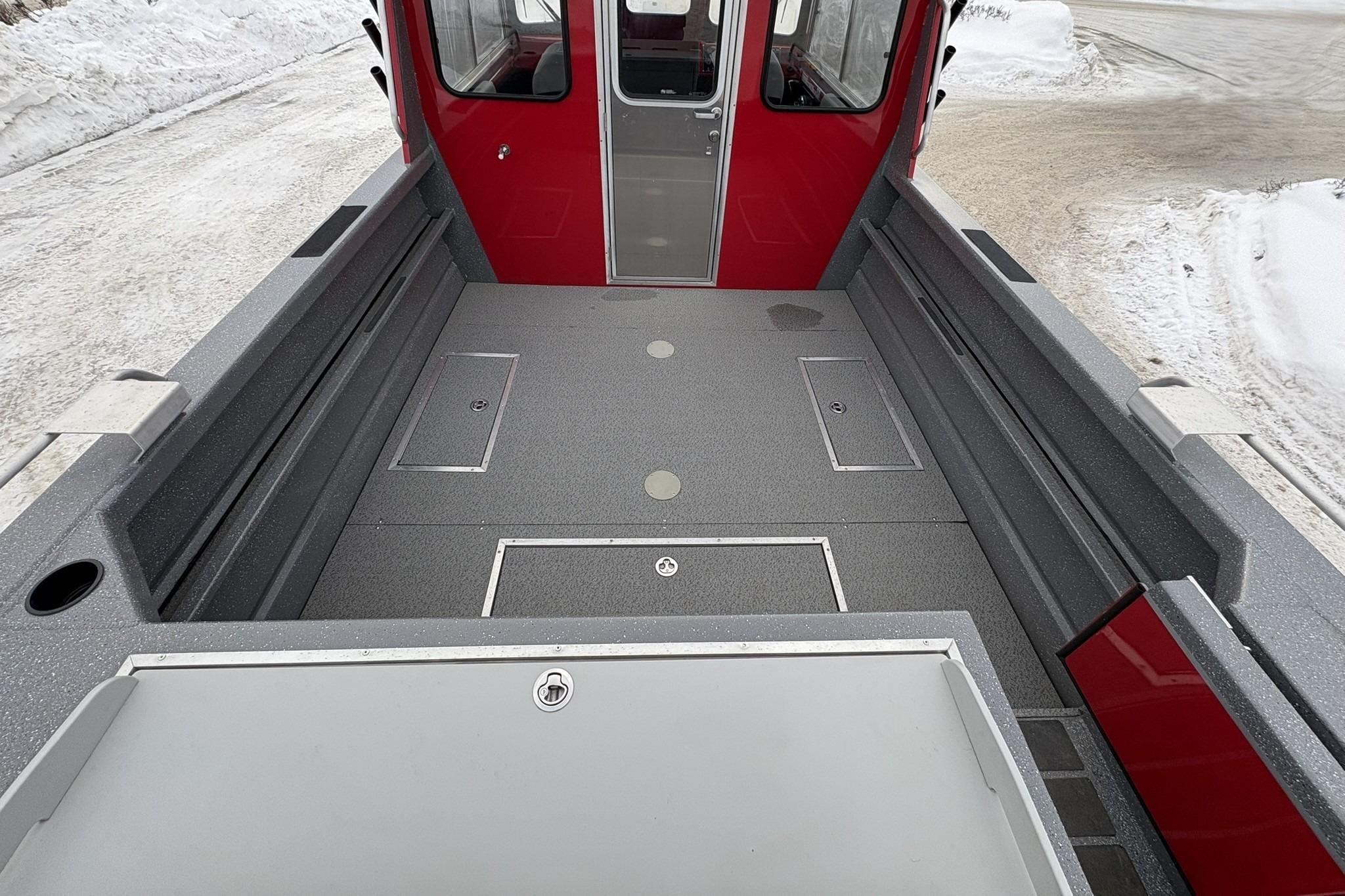 2024 Spartan 240 Maximus Pro boat interior with spacious deck and red cabin.