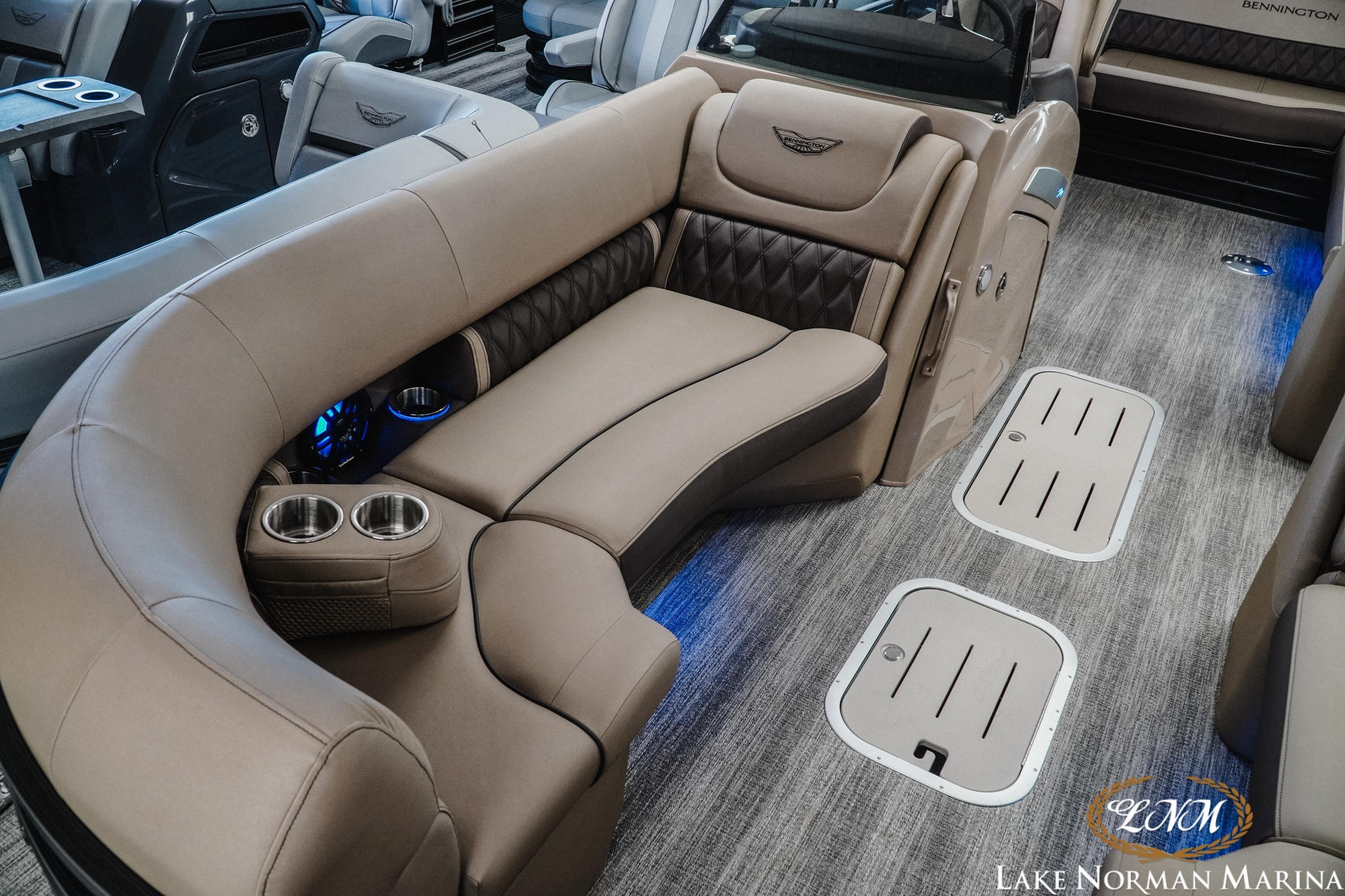 Luxurious interior of 2026 Bennington 24LXSSB pontoon boat with plush seating and cup holders.