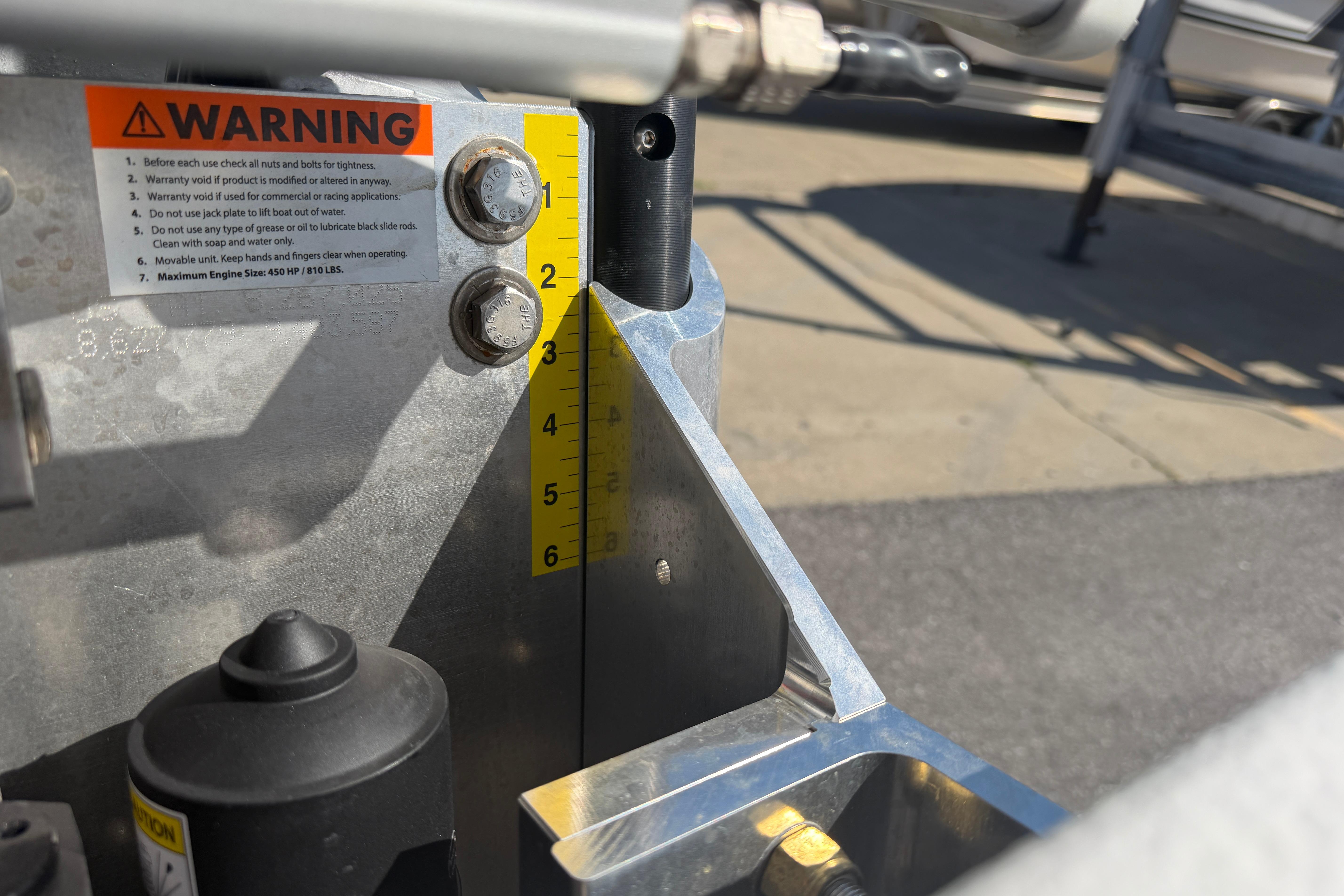 Close-up of Skuta 24 Cat 2026 machinery with warning label and measurement markings.