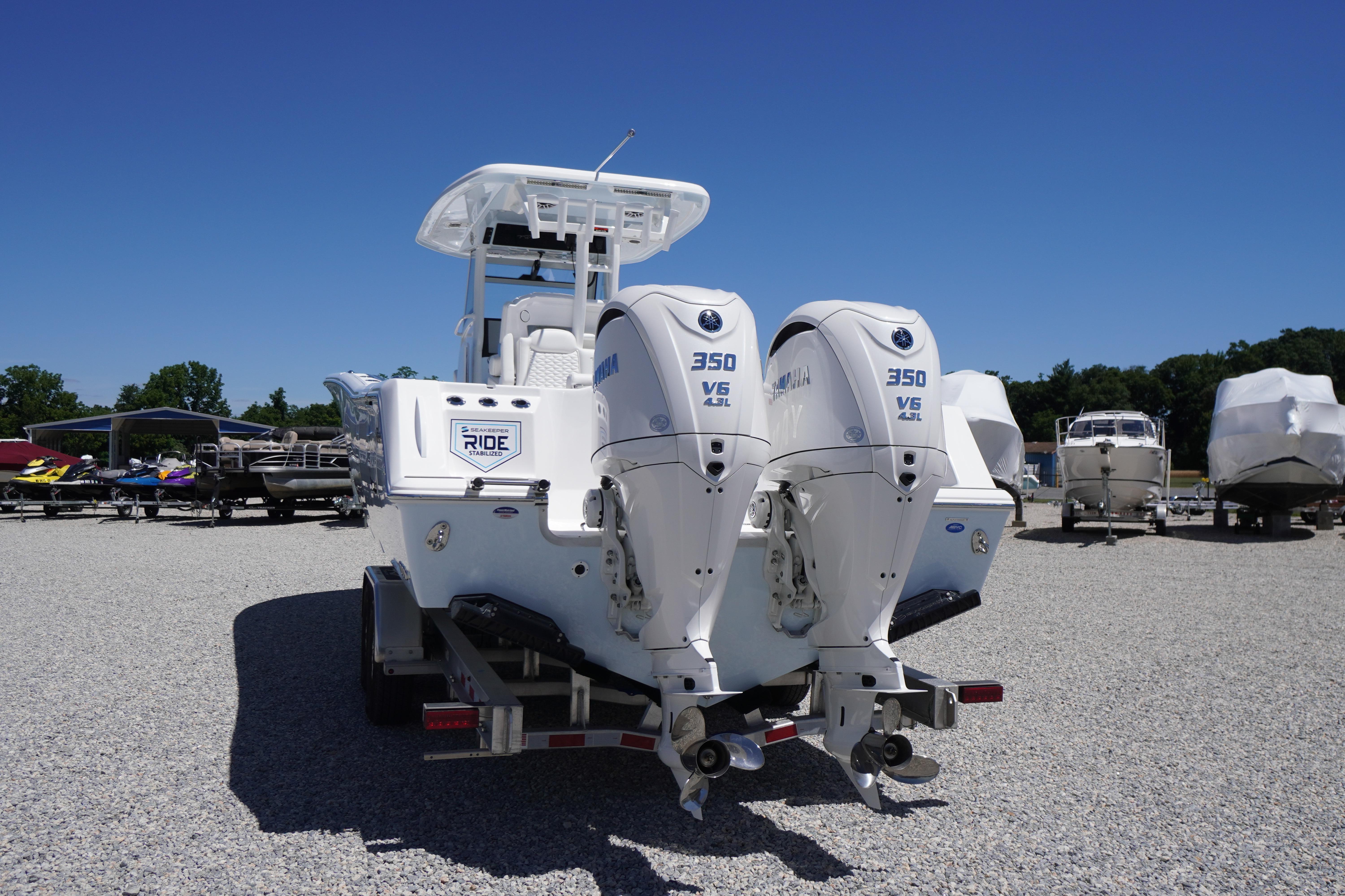 2026 Tidewater 302 CC Adventure boat with dual Yamaha 350 V6 engines on a trailer.