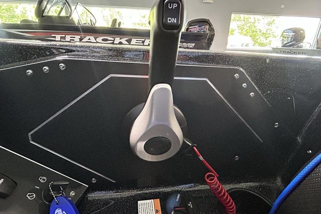 Control panel of a 2026 Skeeter ZX200 boat with throttle lever and keychain.