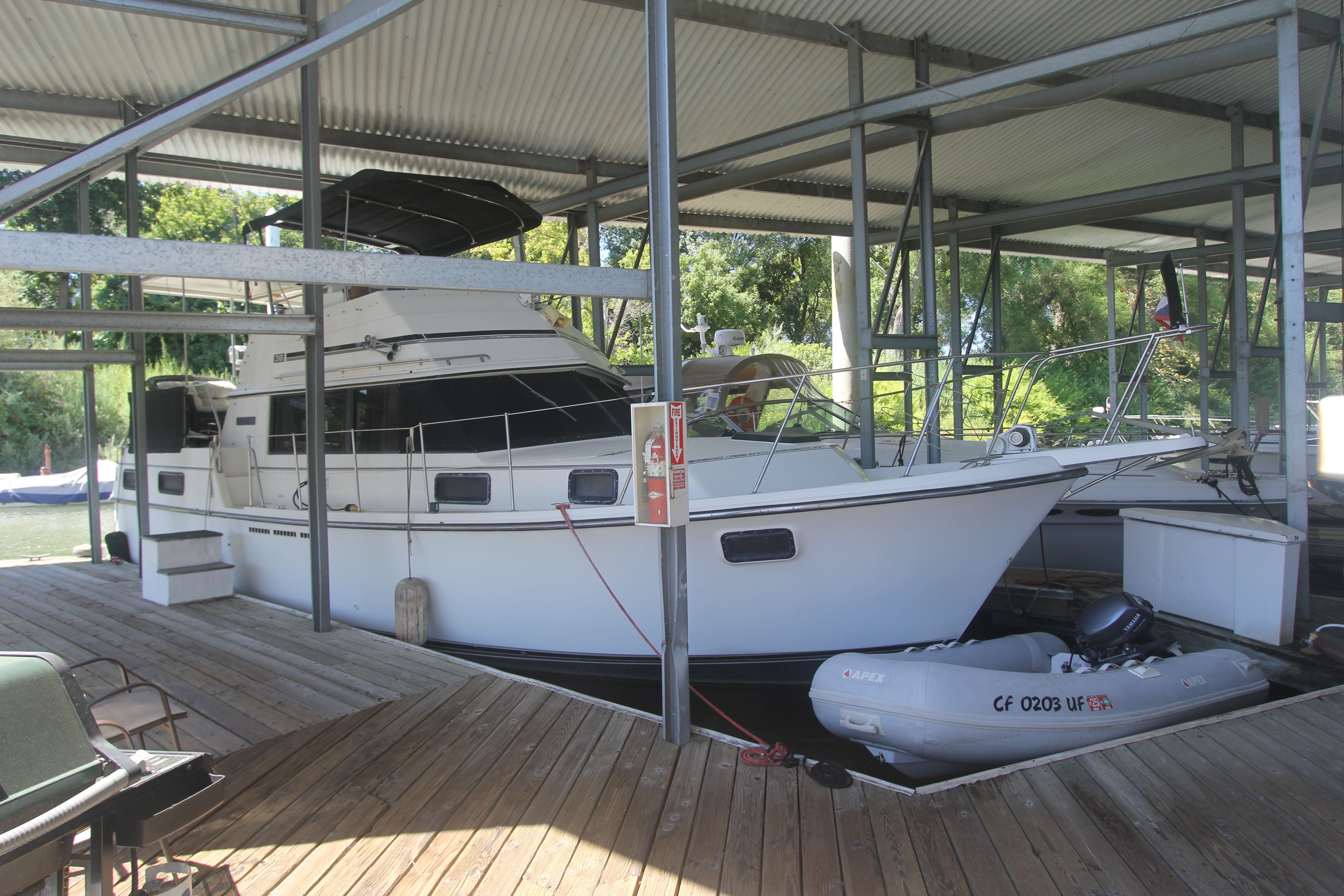 A 1988 Carver 3607 Aft Cabin Motor Yacht docked in a covered marina.