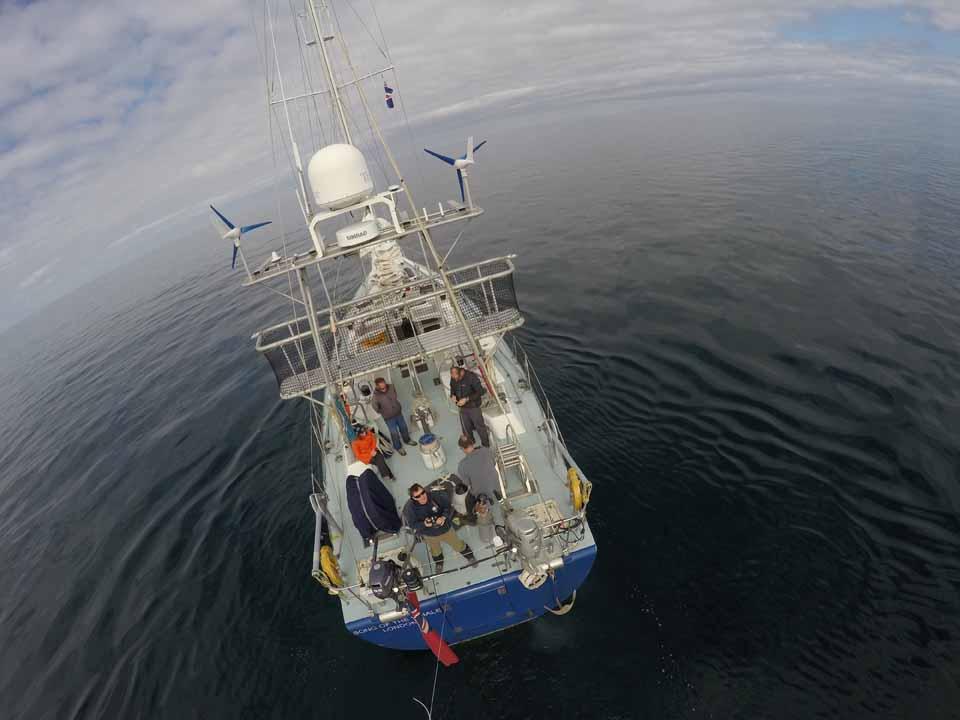 Aerial view of 2004 Custom Simon Rogers One Design yacht on calm sea.