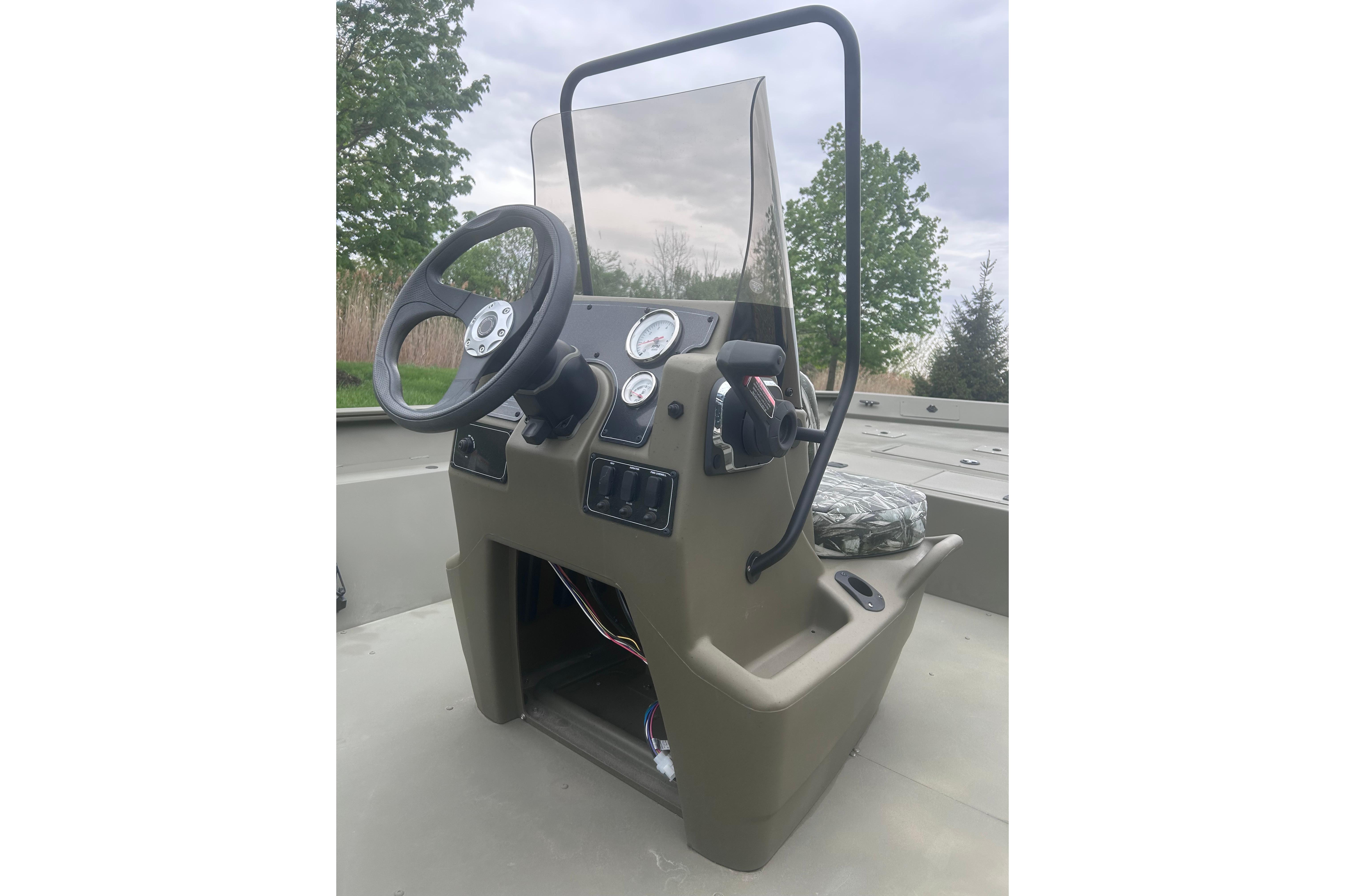 2024 Tracker Grizzly 2072 CC boat console with steering wheel and gauges.