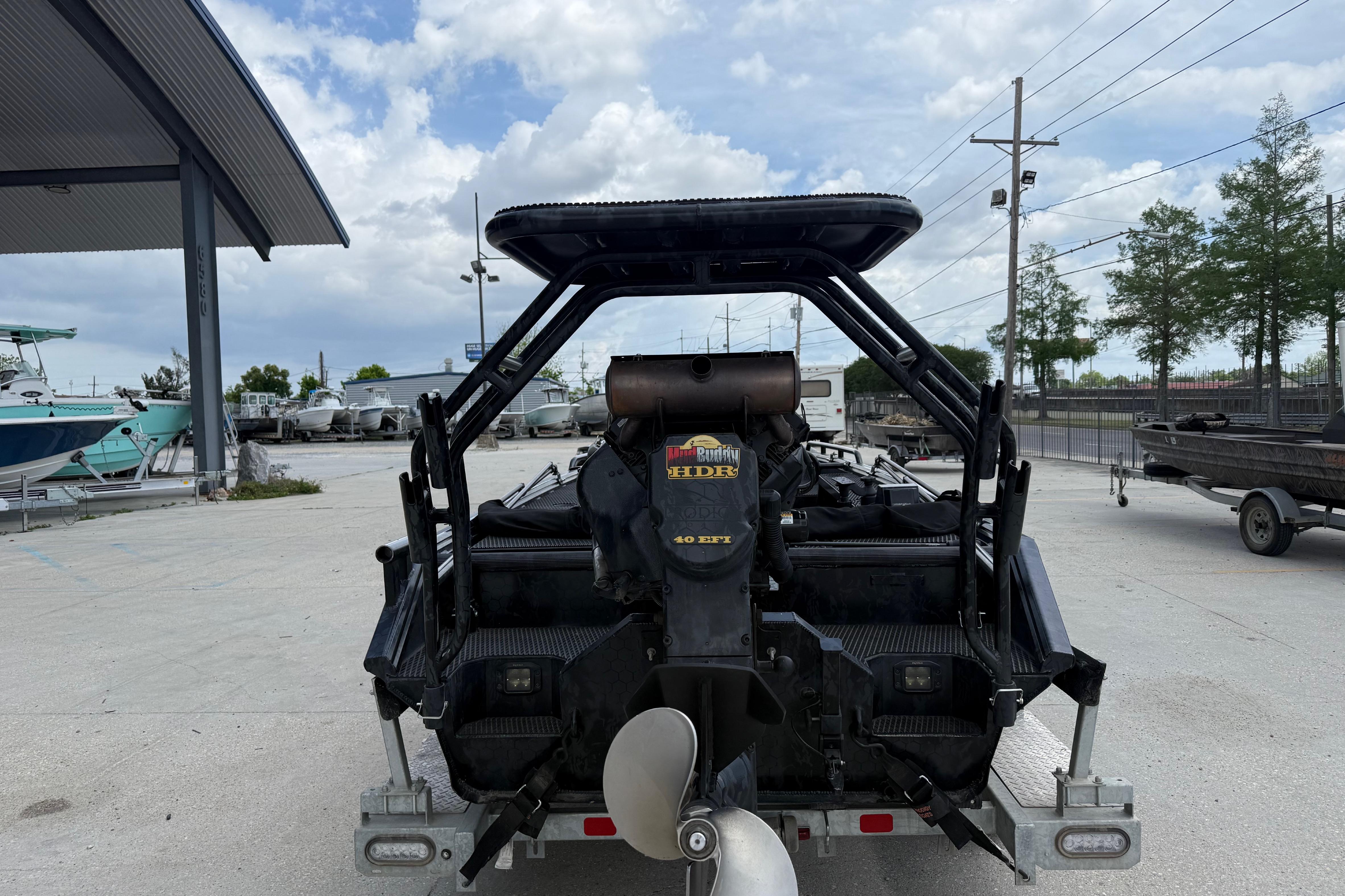 Rear view of a 2024 Prodigy 17 boat with a powerful motor, parked outdoors.