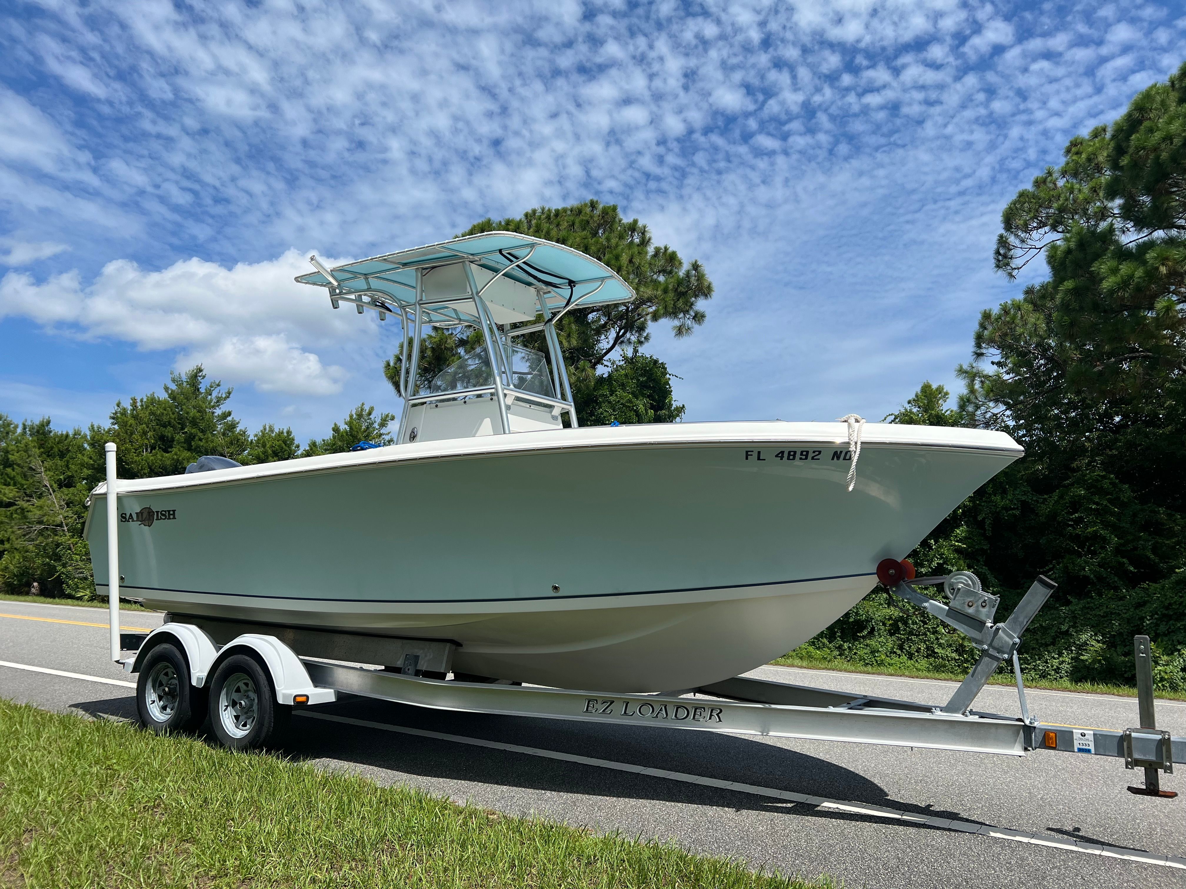 2006 Sailfish 218 CC boat on trailer, blue sky.