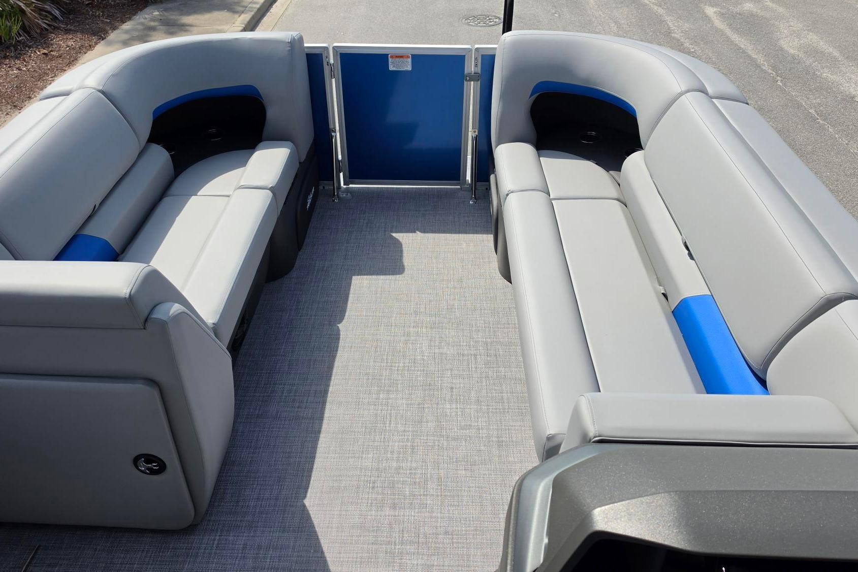 2026 Sun Tracker Party Barge 20 DLX interior with gray and blue seating.