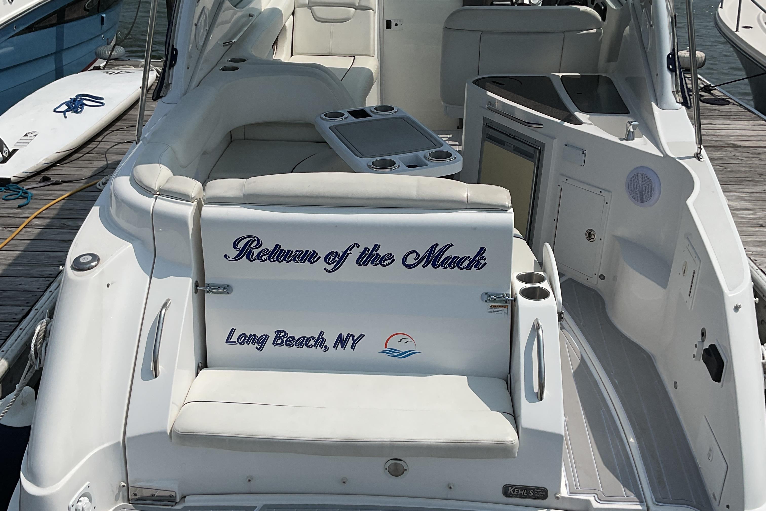 2013 Rinker 290 Express Cruiser docked, featuring "Return of the Mack" text, Long Beach, NY.