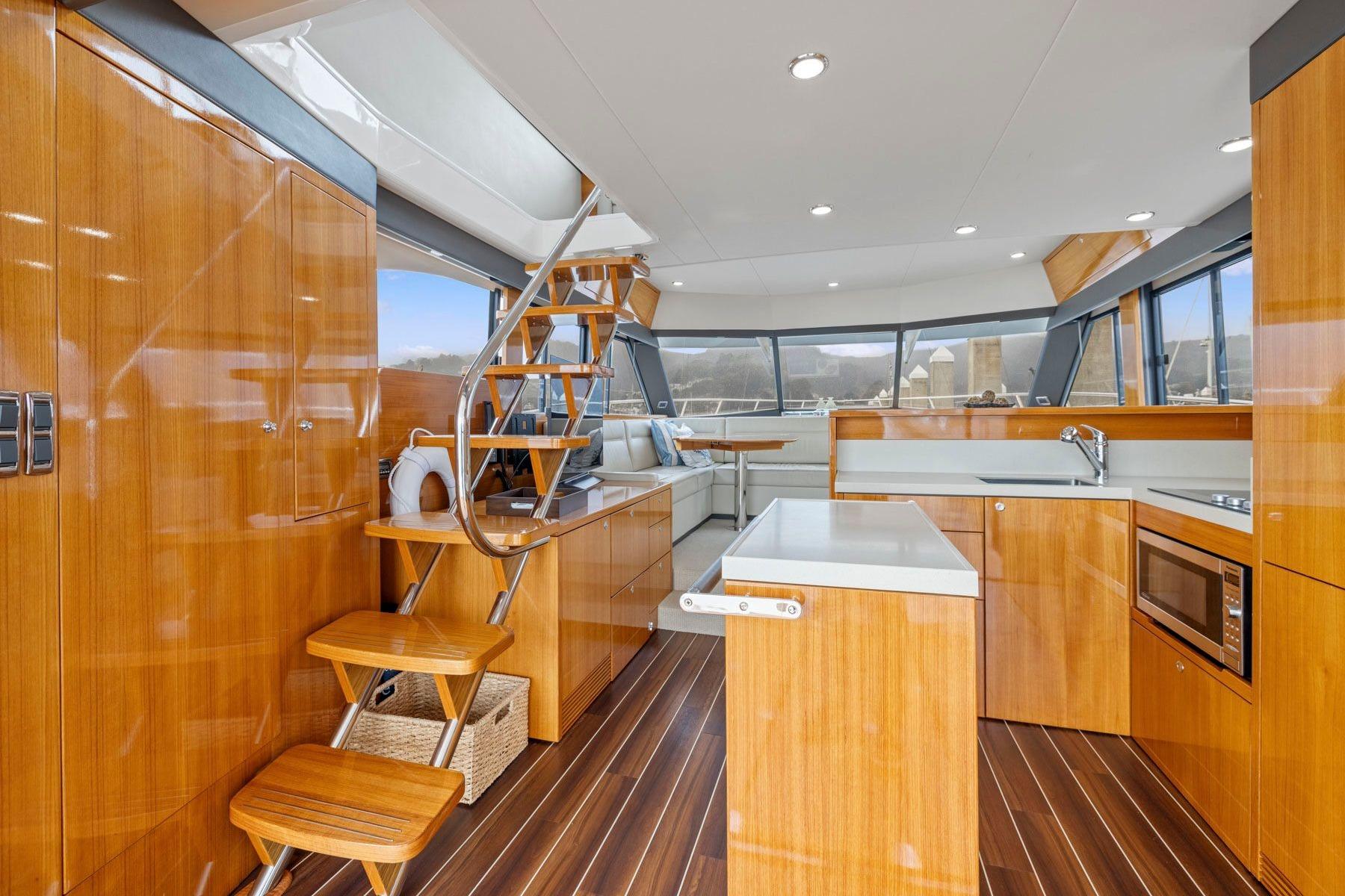 Luxurious interior of 2014 Maritimo M50 yacht with modern kitchen and wooden finishes.