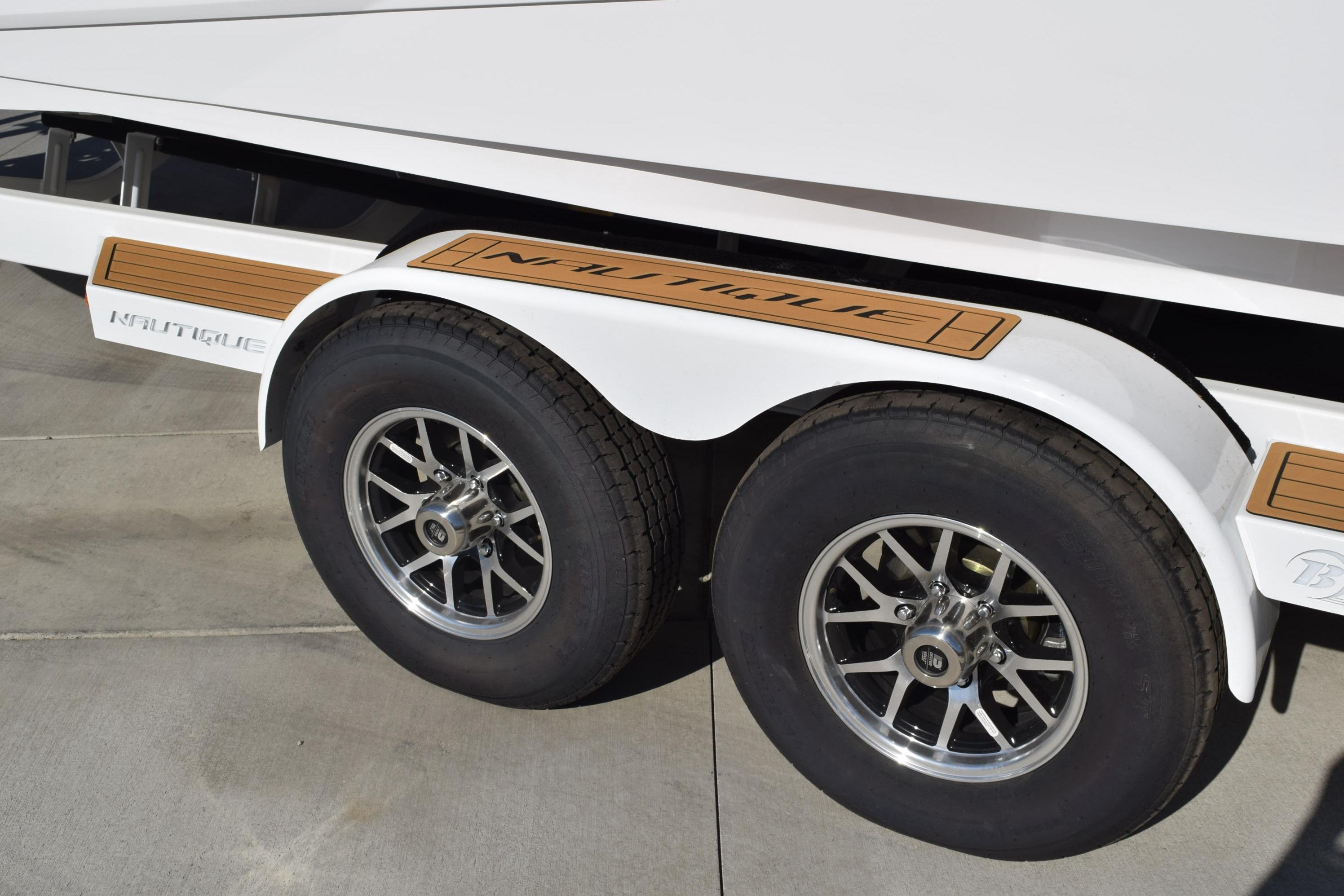 2026 Nautique Super Air Nautique G23 trailer with dual wheels and branded fender.
