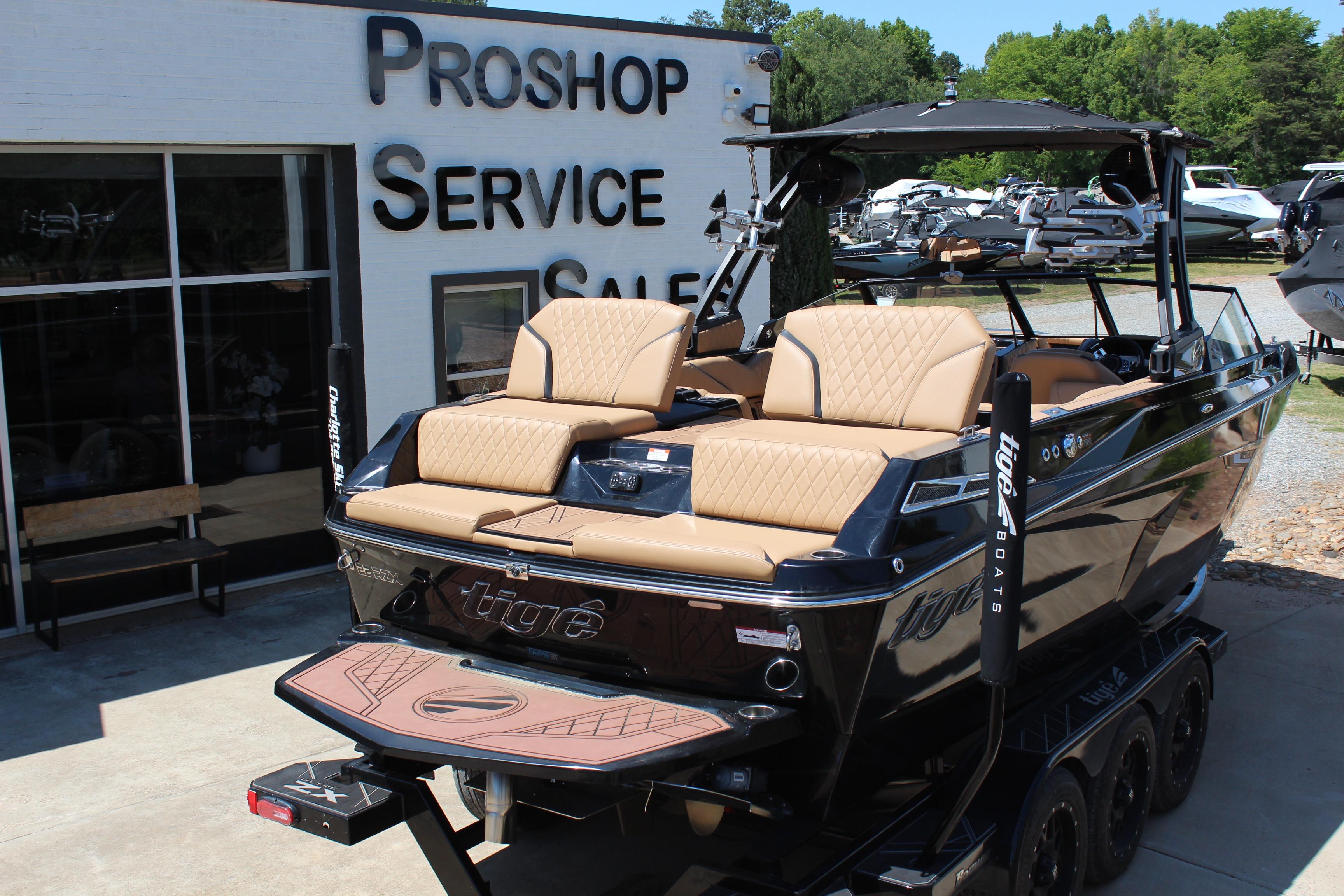 2022 Tigé 22RZX boat at a pro shop, featuring luxurious seating and sleek design.