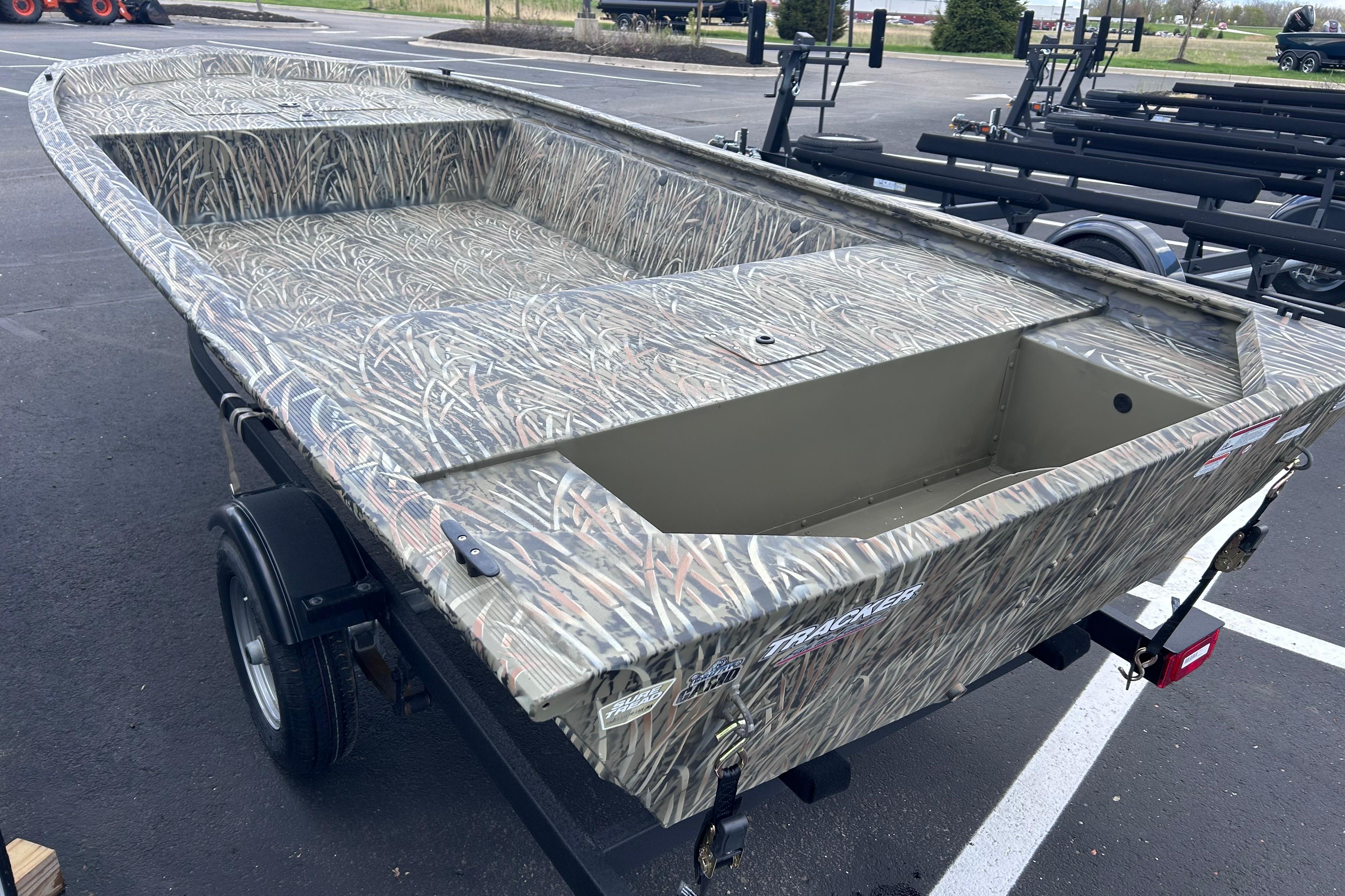 2026 Tracker Grizzly 1648 Utility boat with camouflage design on a trailer.