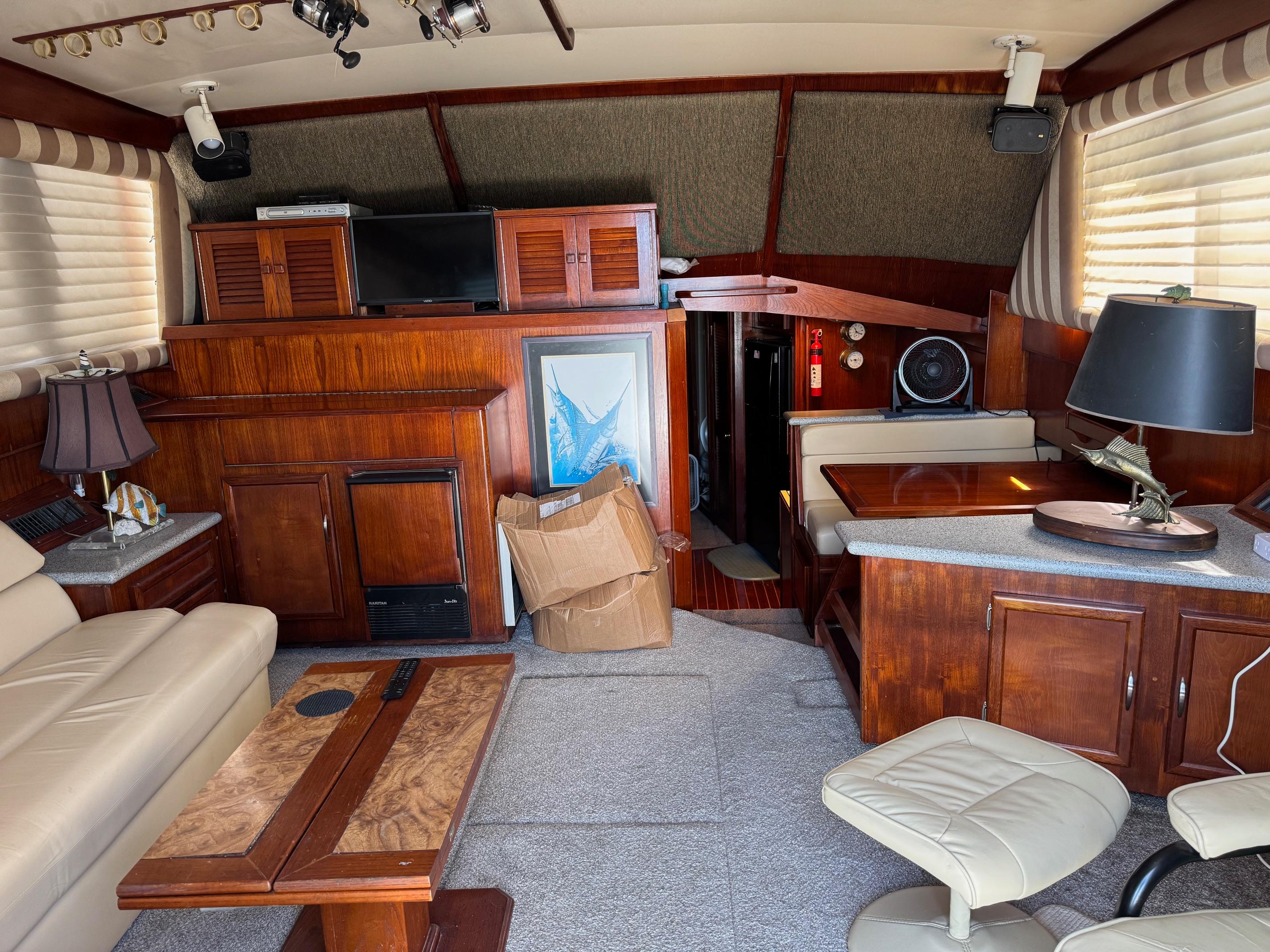 Interior of a 1982 Viking 46 Convertible yacht with wood furnishings and cozy seating.