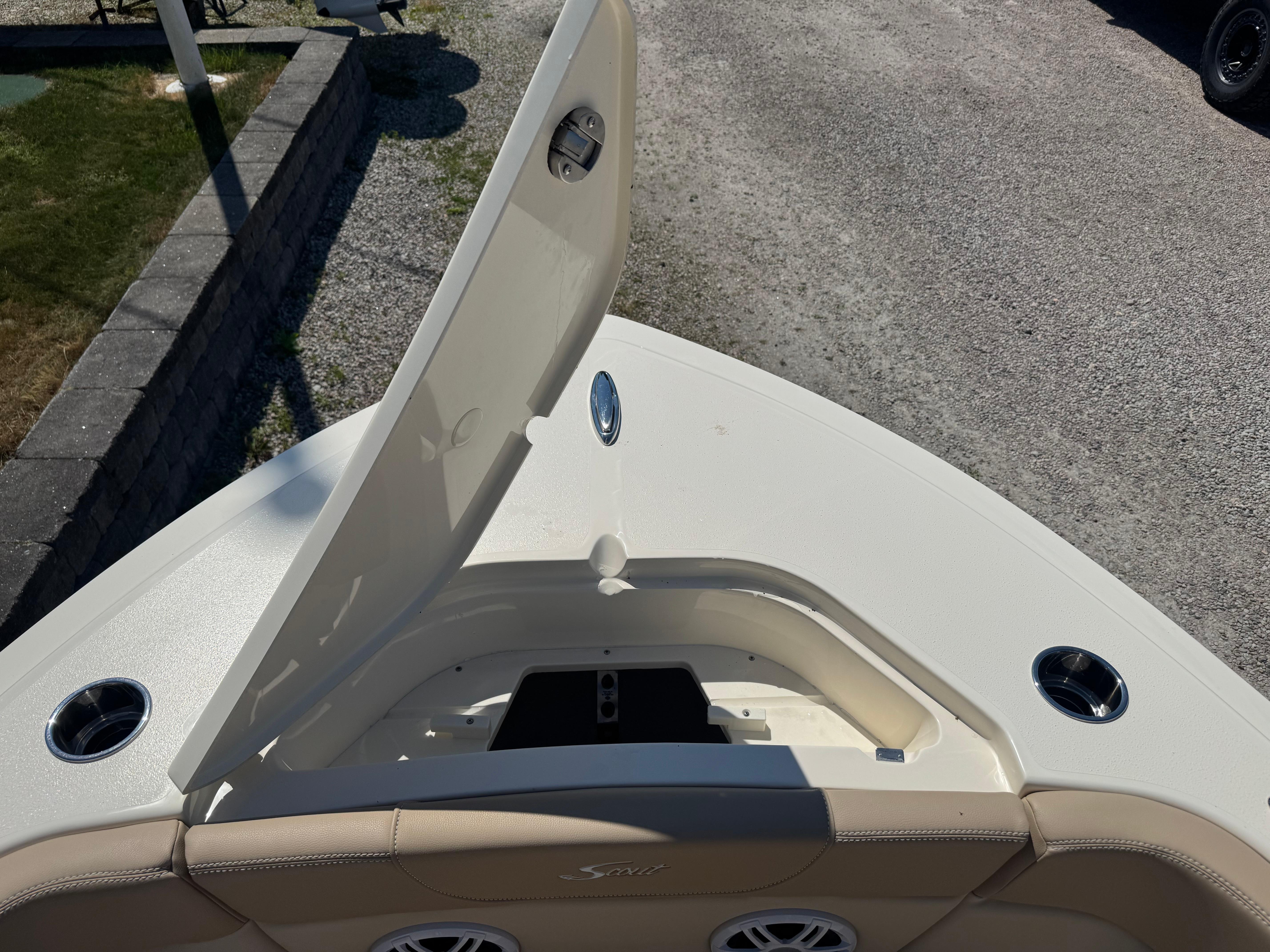 2025 Scout 215 Dorado boat with open storage compartment on deck.