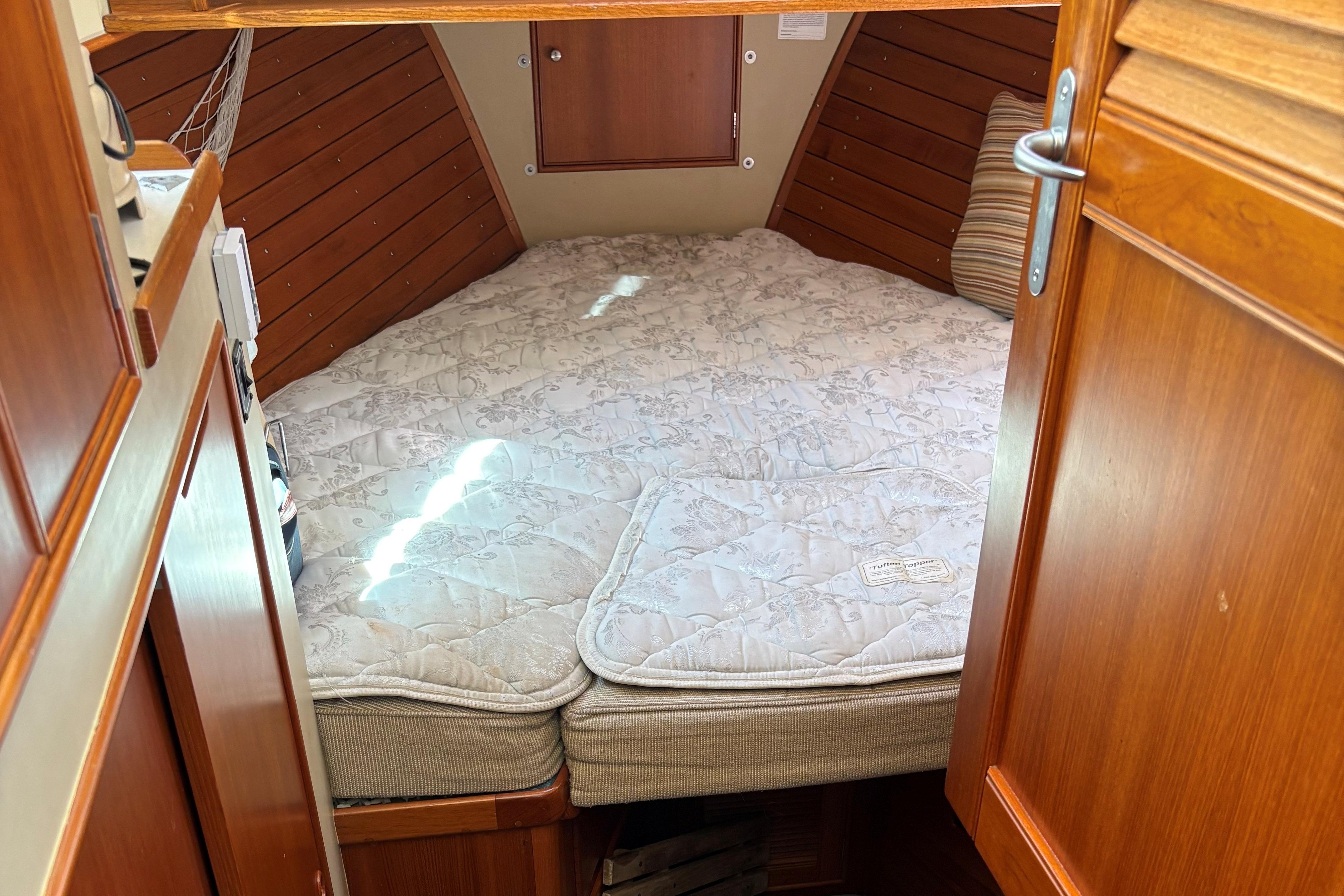 Cozy cabin interior of 1990 Grand Banks Classic boat with a comfortable bed.