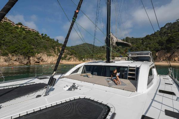 Luxury Privilege Signature 580 yacht anchored near scenic coastline, 2025 model.