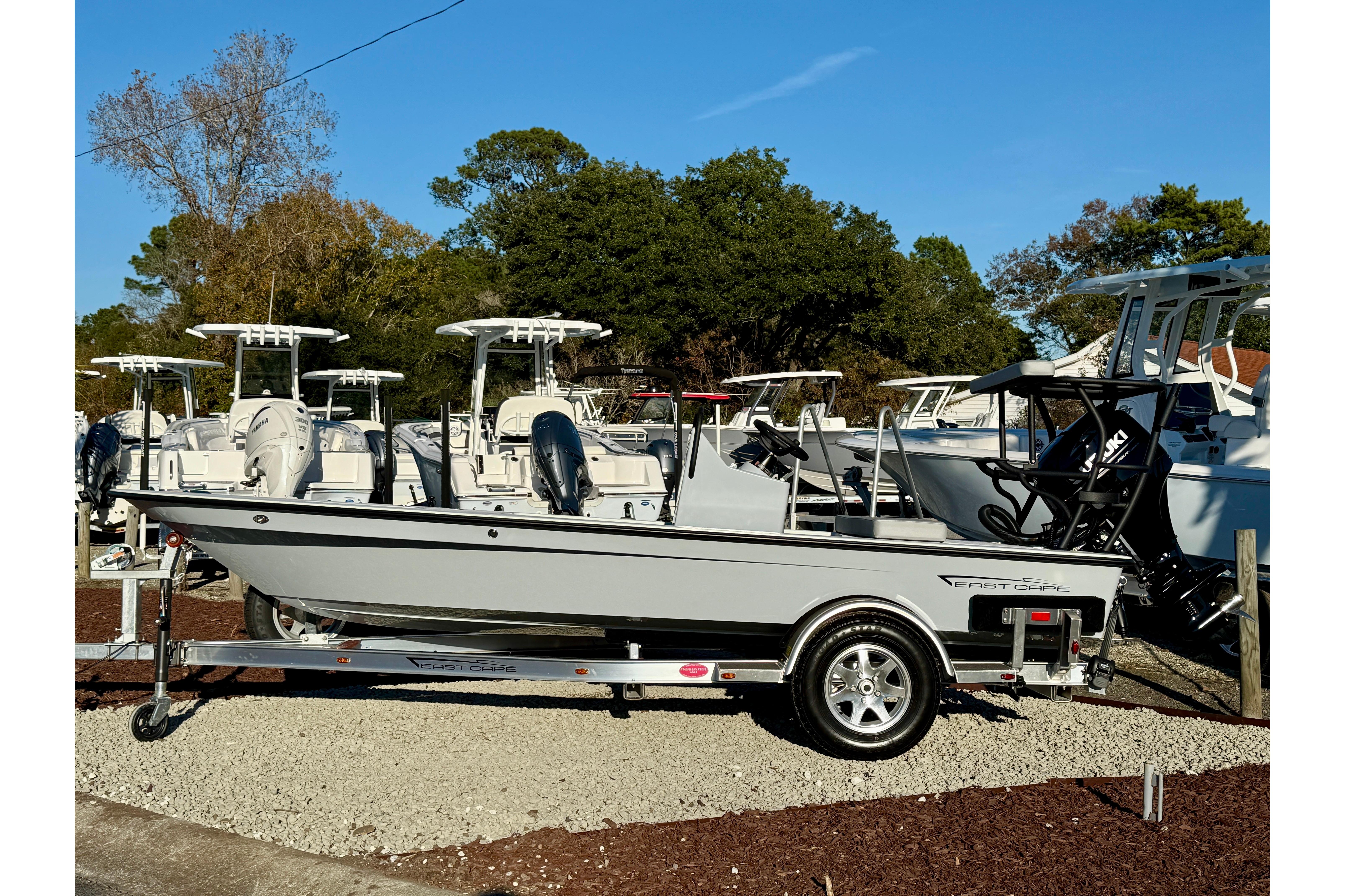 2026 East Cape EVO 17V boat on trailer, surrounded by other boats, under clear blue sky.
