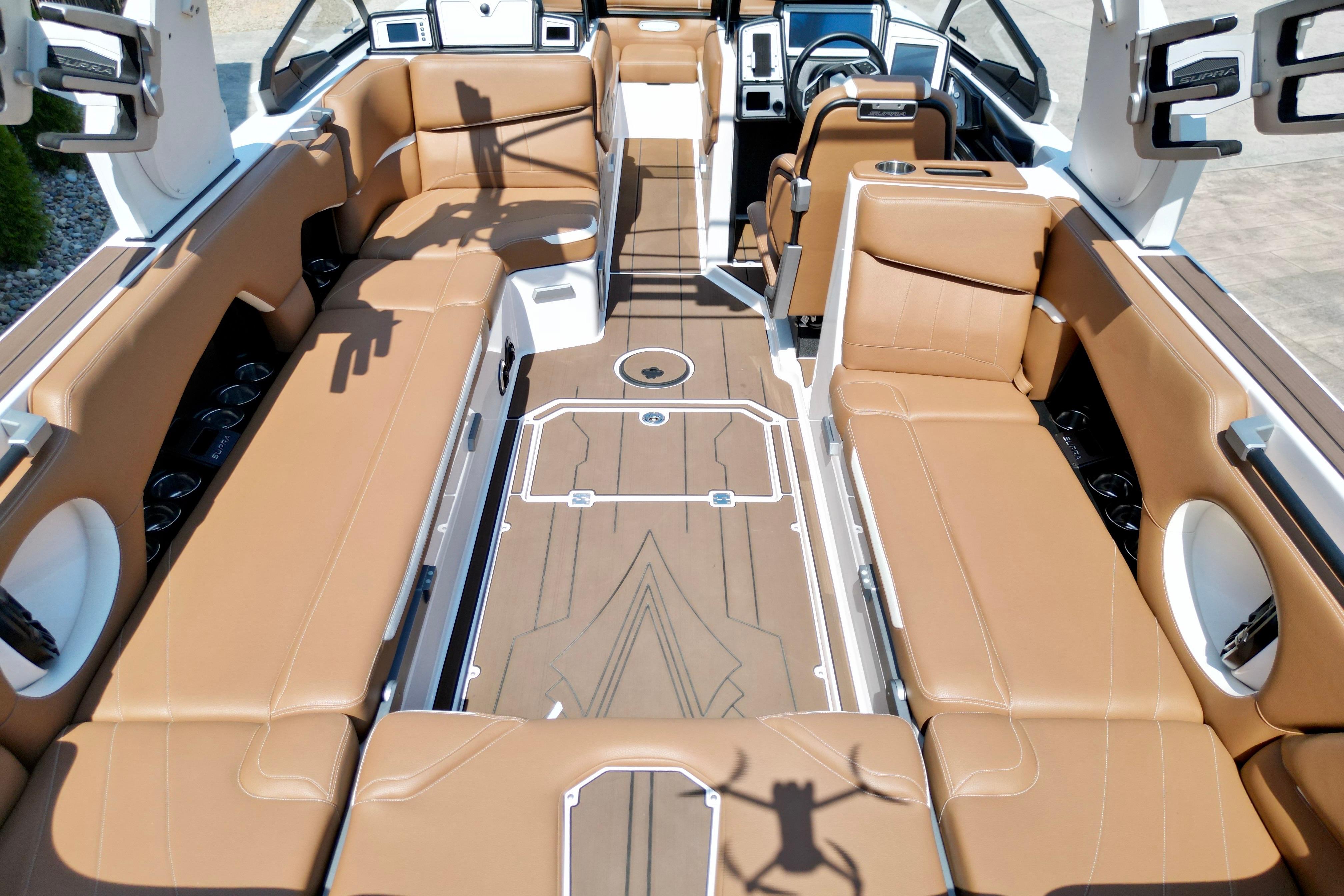 2021 Supra SE boat interior with tan leather seating and modern design.