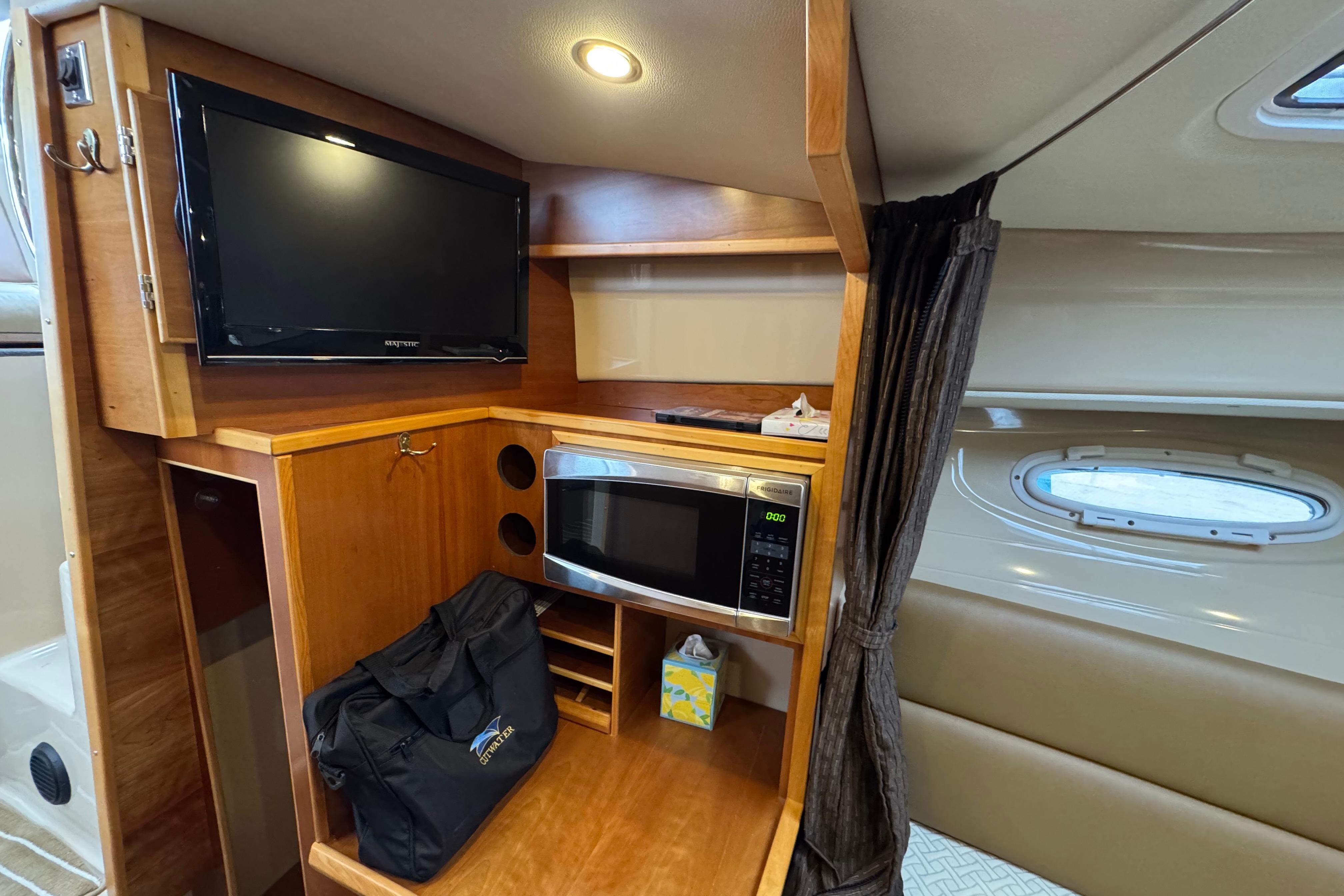 2014 Cutwater 28 interior with TV, microwave, and storage space.