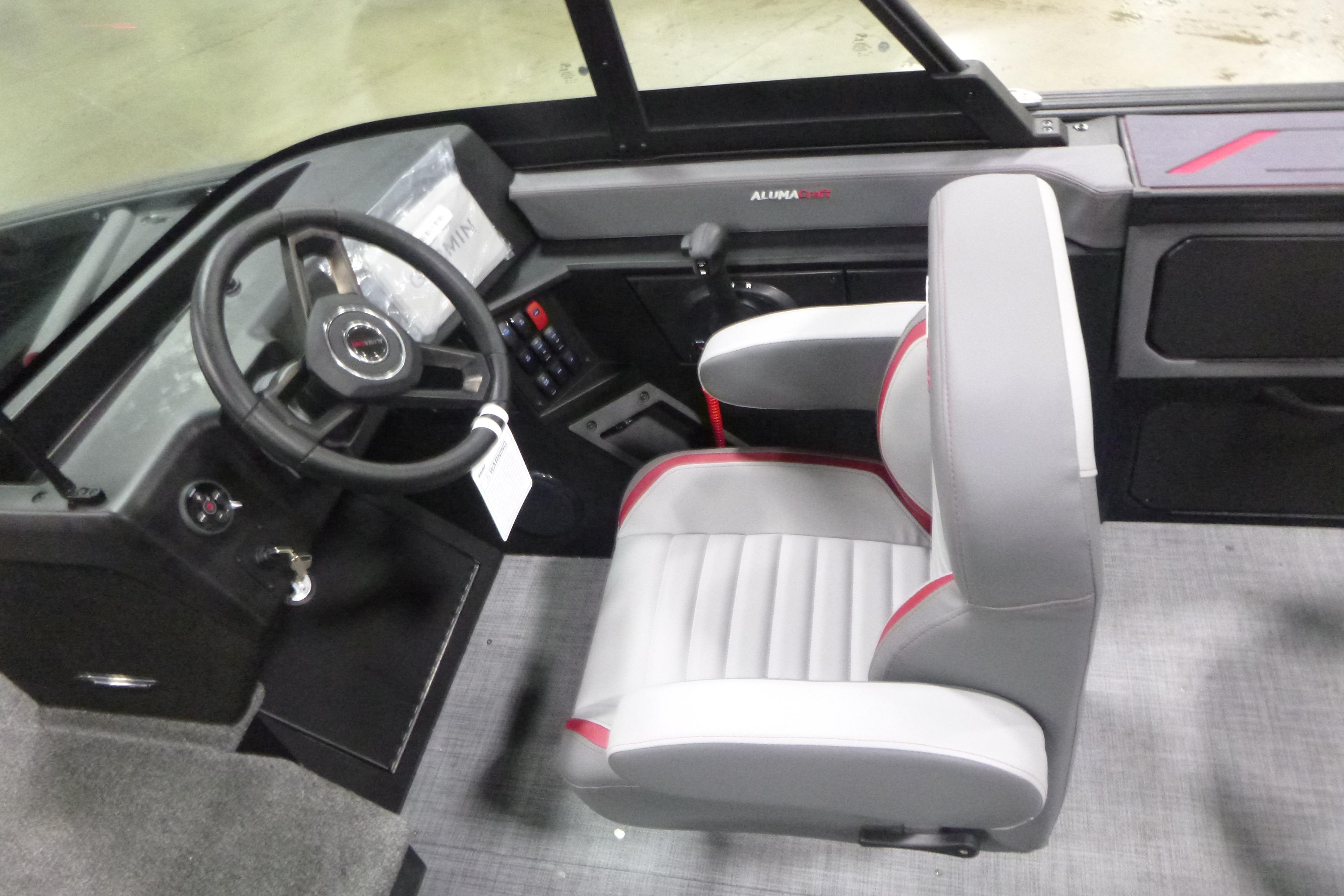 2026 Alumacraft Trophy 205X Sport boat interior with steering wheel and captain's chair.