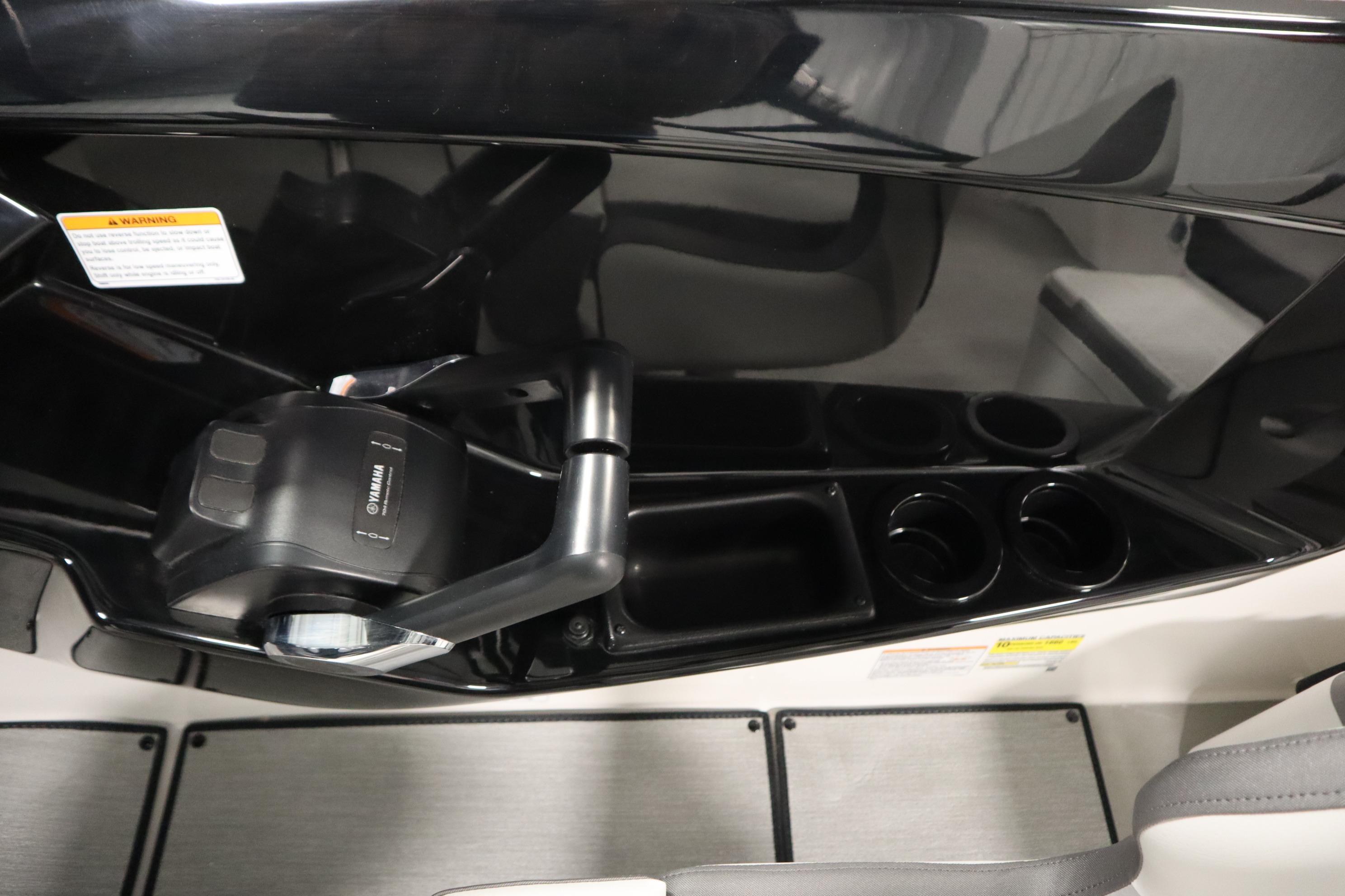 2026 Yamaha Boats AR220 cockpit with throttle control and cup holders.