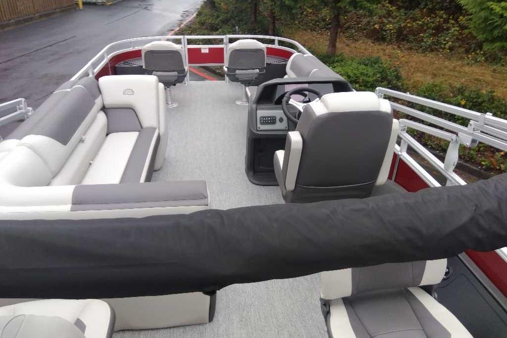 2026 Sun Tracker Fishin' Barge 22 DLX interior with seating and steering console.
