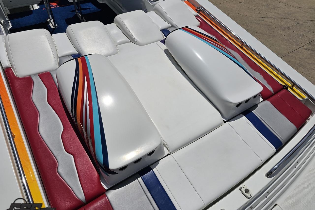 2002 Formula 382 FASTech boat interior with colorful striped upholstery design.