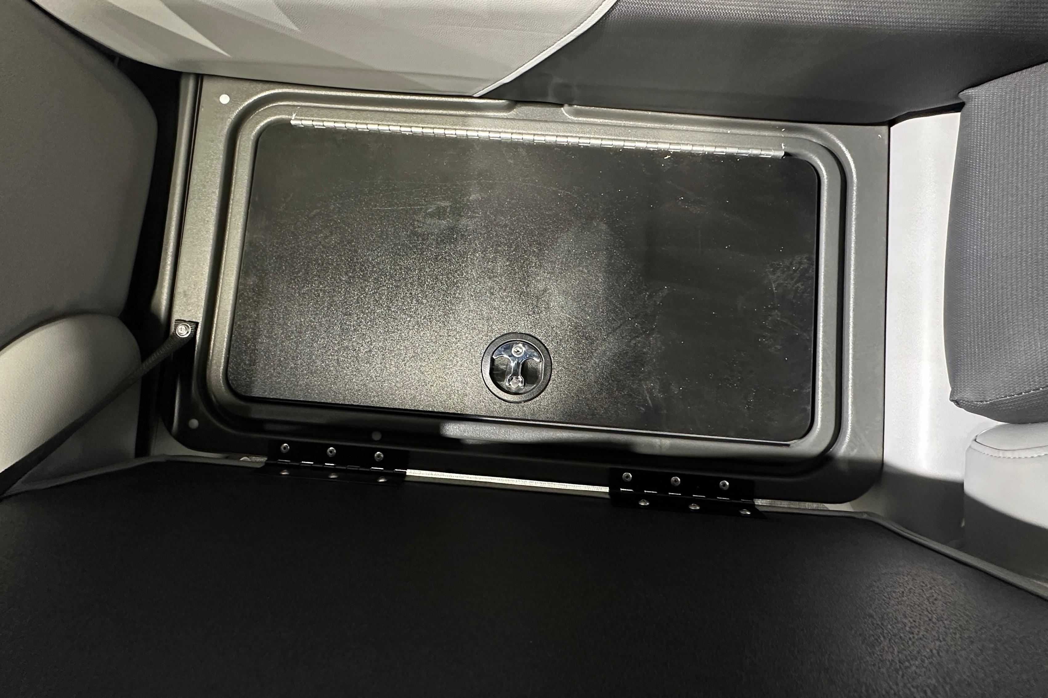 Storage compartment in 2026 Sun Tracker SportFish 22 DLX boat interior.