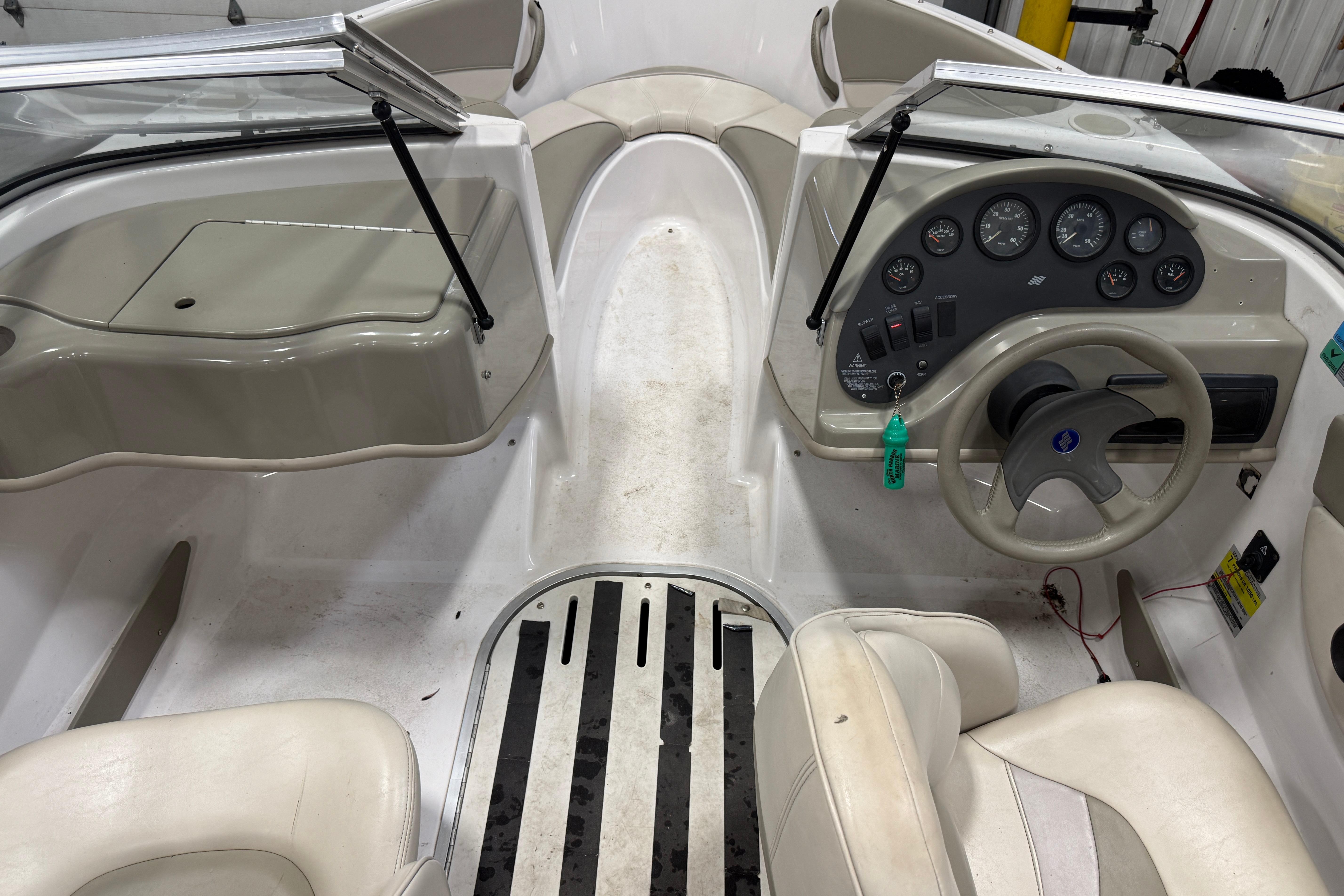 1999 Four Winns 170 Horizon LE boat interior with steering wheel and dashboard controls.