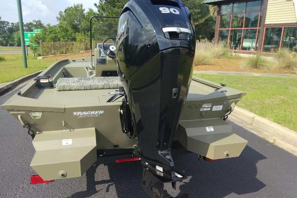 2026 Tracker Grizzly 1860 CC boat with powerful outboard motor, parked outdoors.