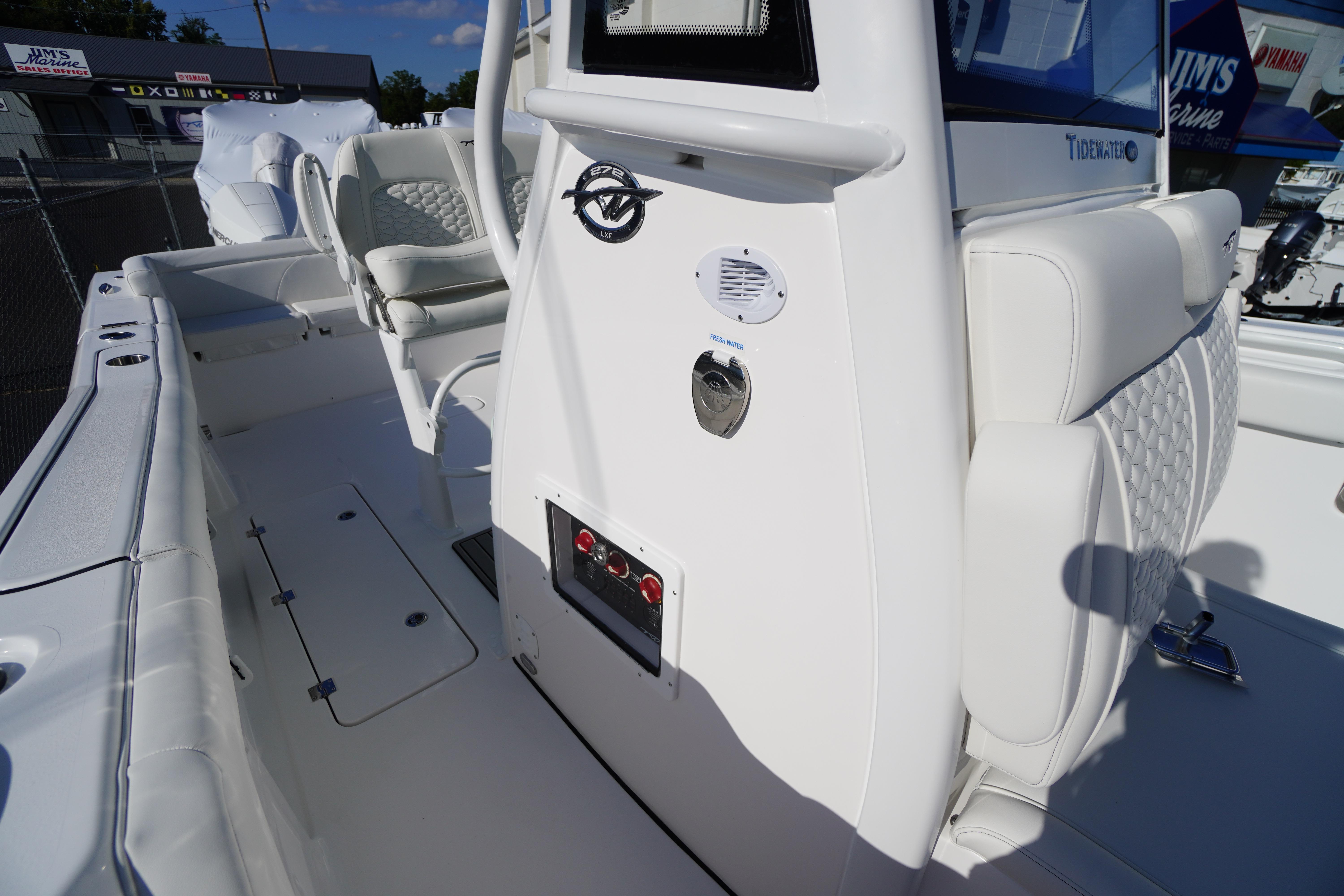 2026 Tidewater 272 LXF boat interior with white seating and control panel.