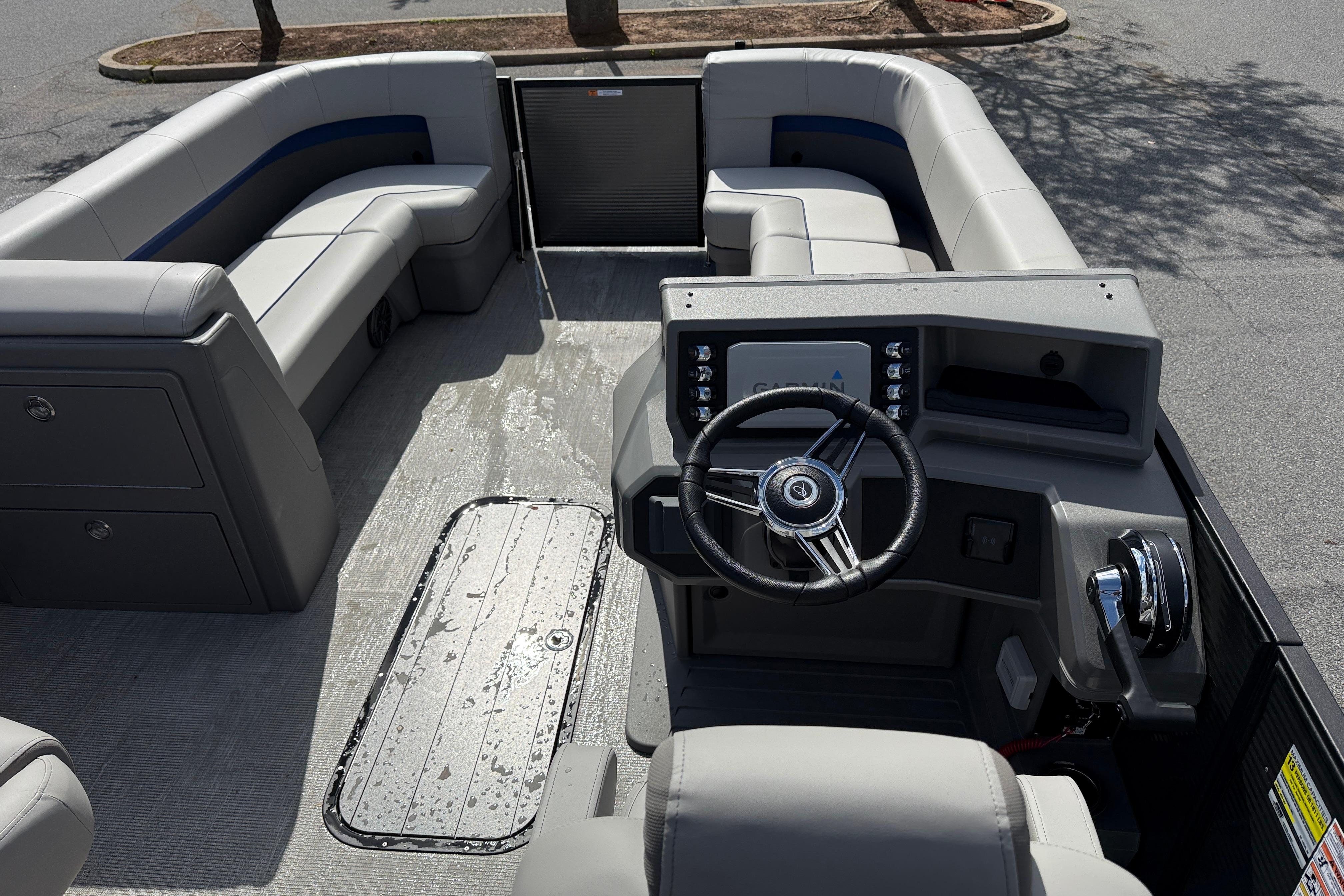 2025 Qwest Splash Pad E-Class boat interior with steering console and seating.