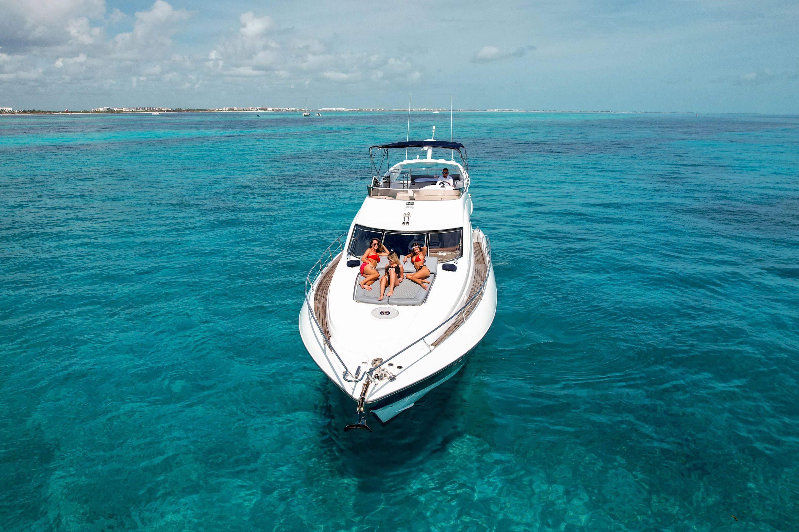 Luxury yacht Sunseeker Manhattan 56 from 2003 on turquoise waters.