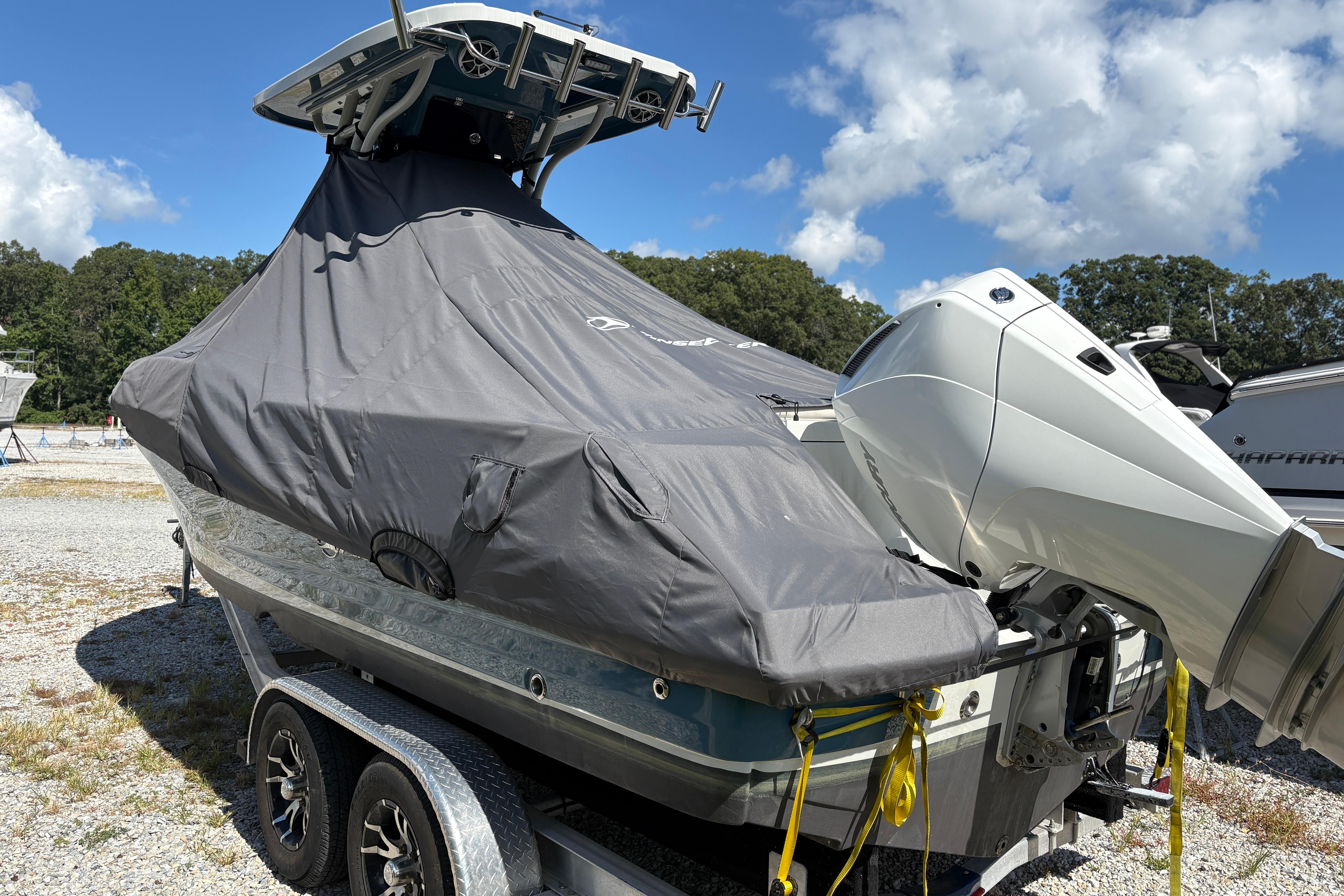 2023 Finseeker 230cc boat covered, on trailer, with outboard motor, under blue sky.