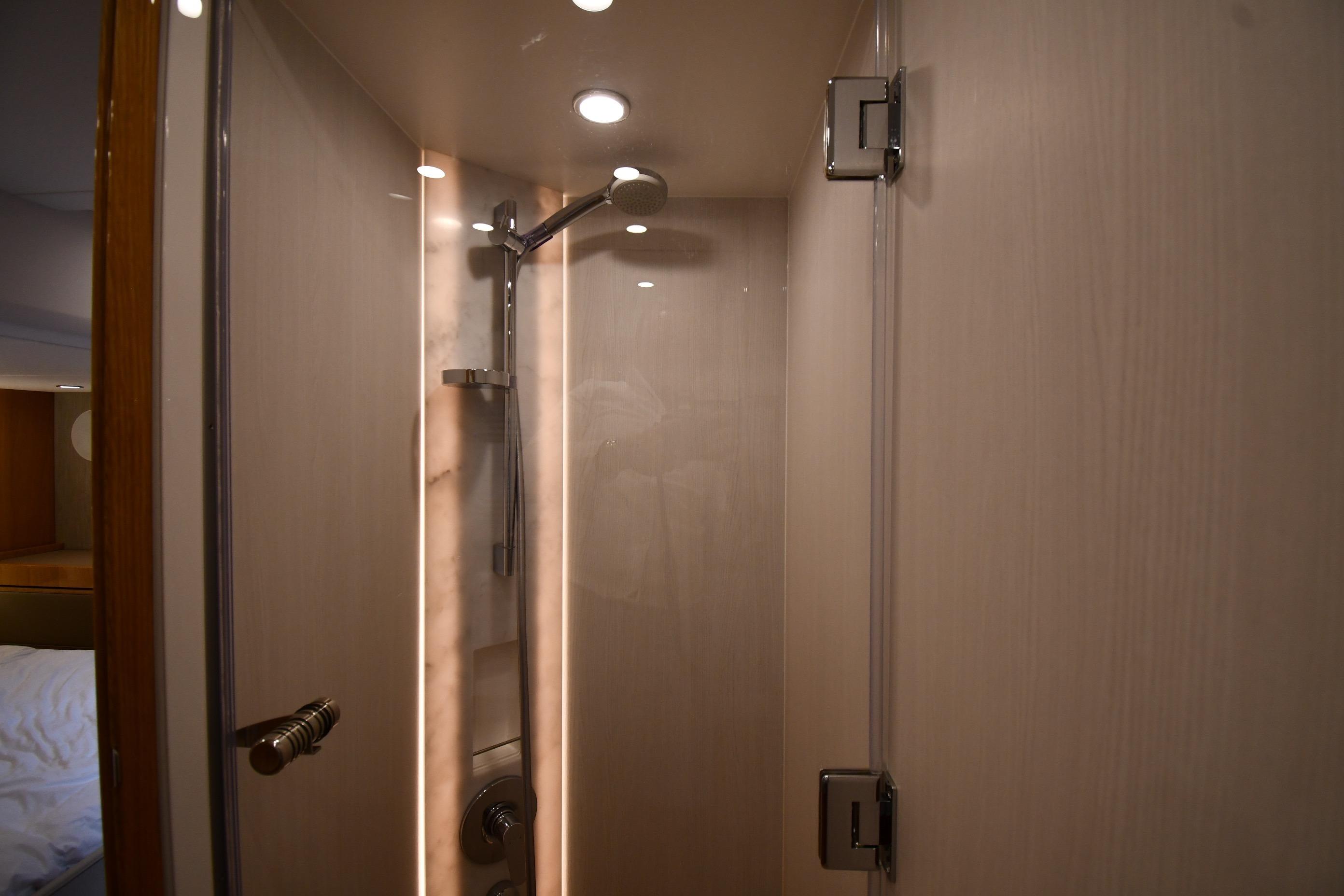 Luxurious shower area in 2024 Fairline G50 Targa yacht, featuring modern fixtures and lighting.