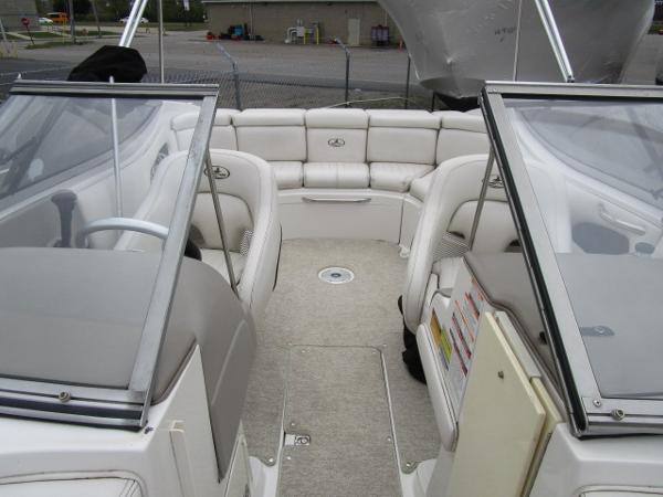 2004 Ebbtide 22 Mystique boat interior with white seating and open deck layout.