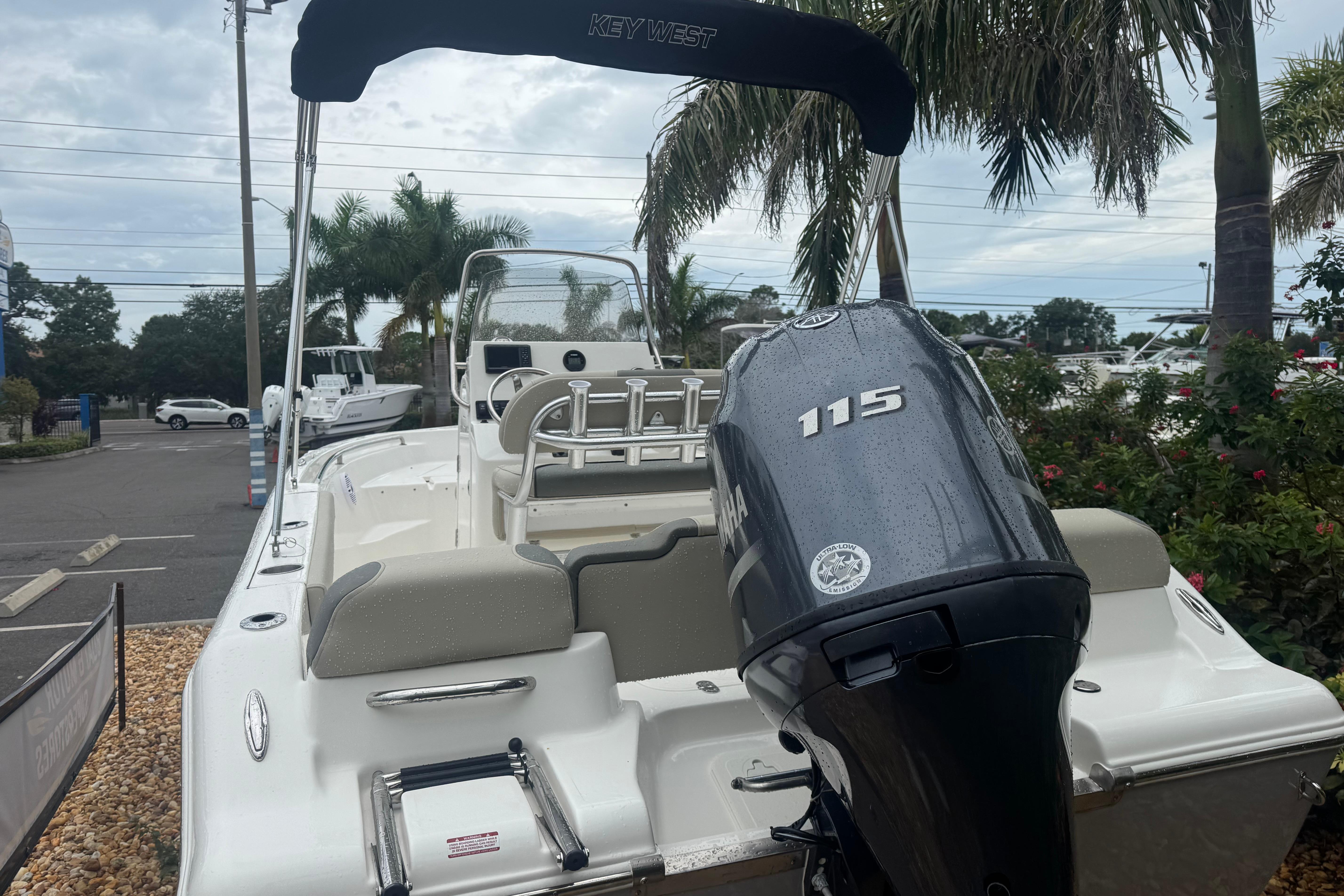 2026 Key West 189 FS boat with Yamaha 115 engine, parked near palm trees.