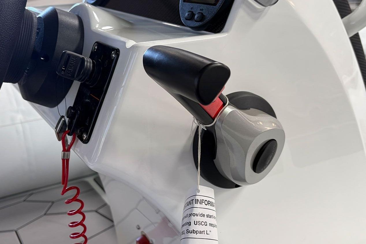 Close-up of 2026 Highfield Sport 460 boat throttle control with safety lanyard.