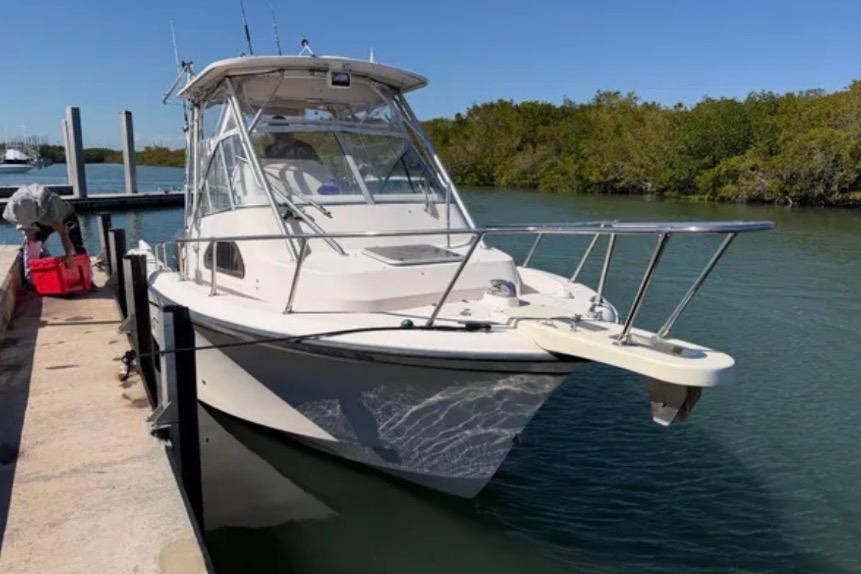 2006 Grady-White Sailfish 282 boat docked by a serene waterway.