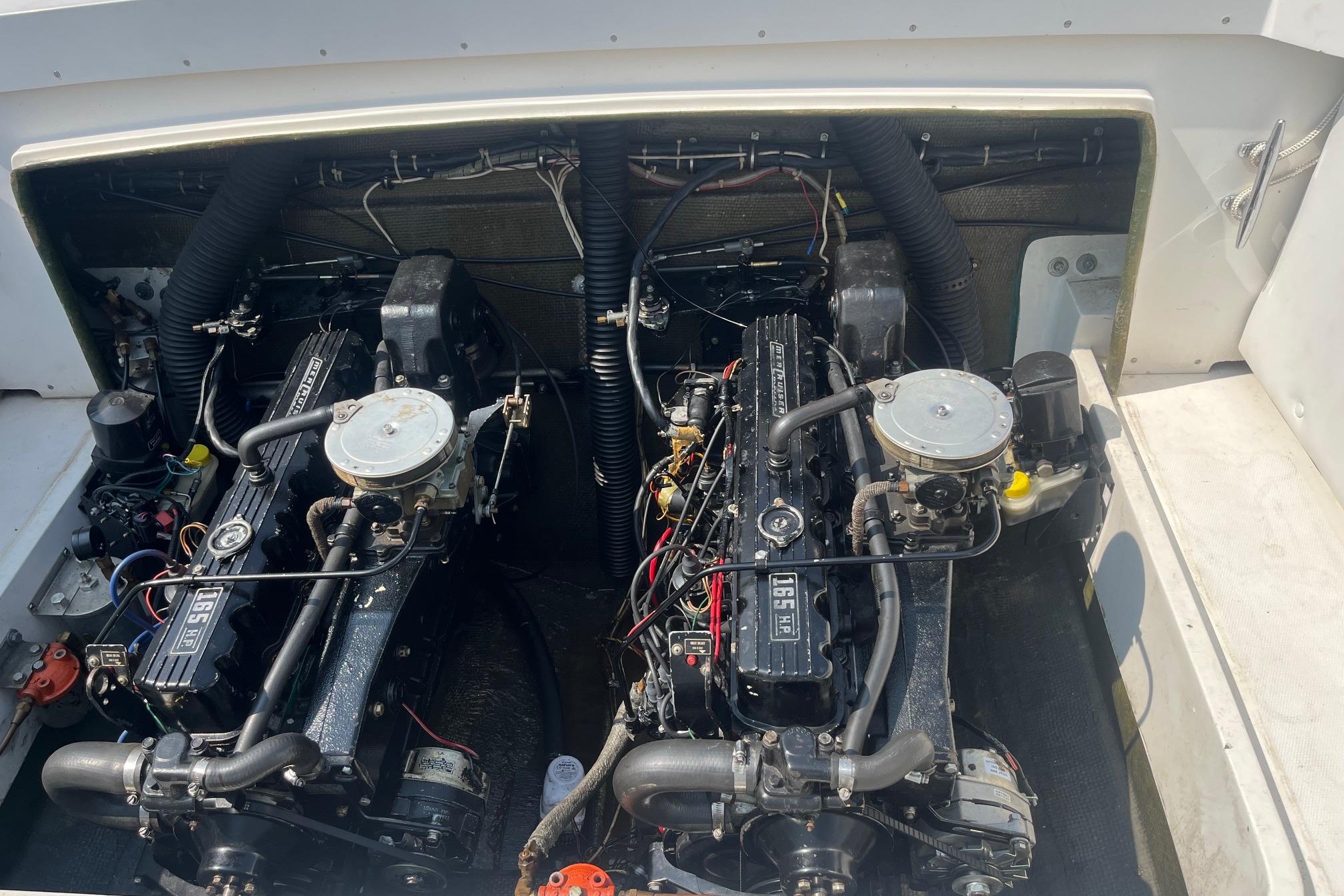 Engine compartment of a 1975 Bertram 26 Moppie boat, showcasing dual engines.