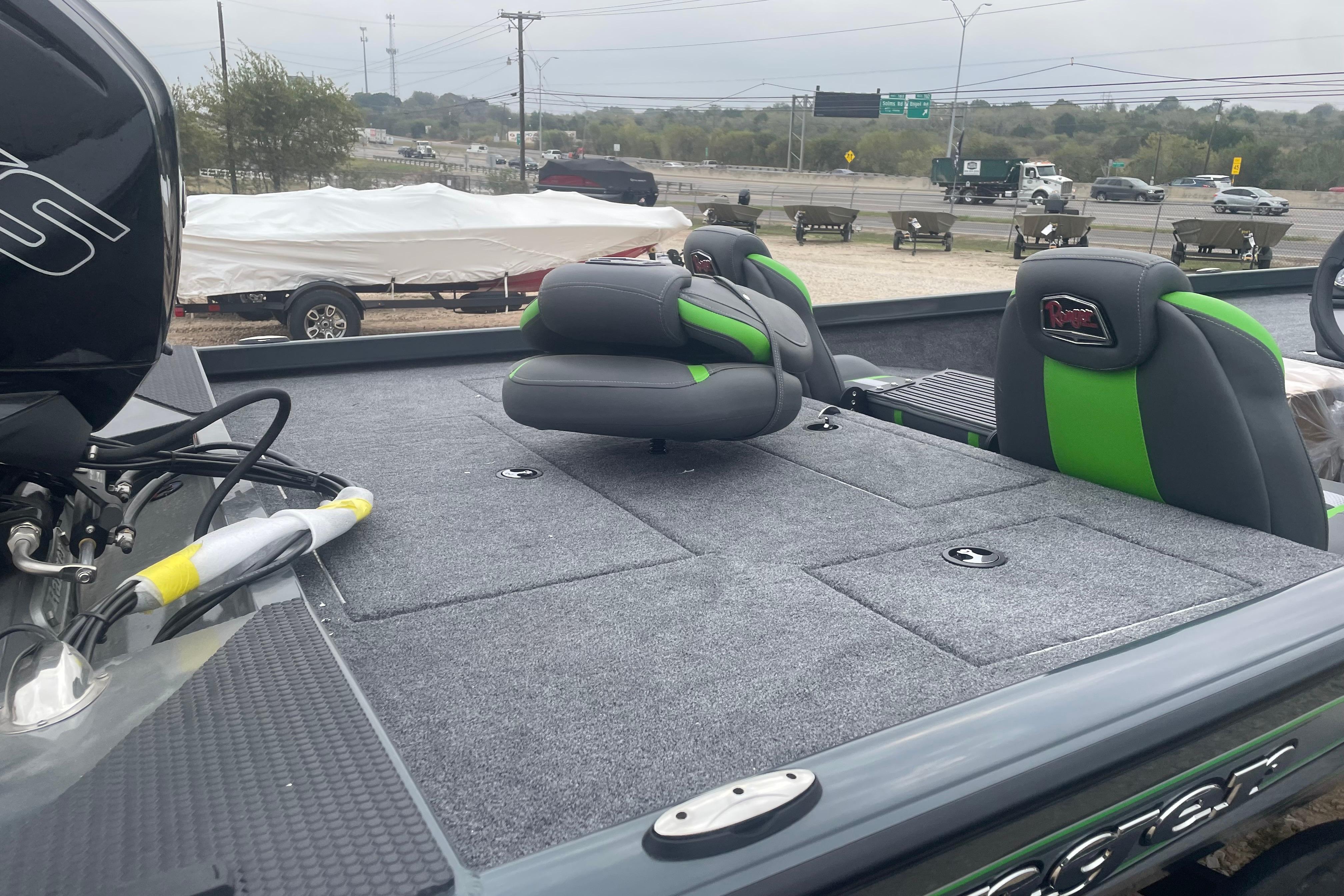 2026 Ranger RT188 boat with gray and green seating, parked outdoors.