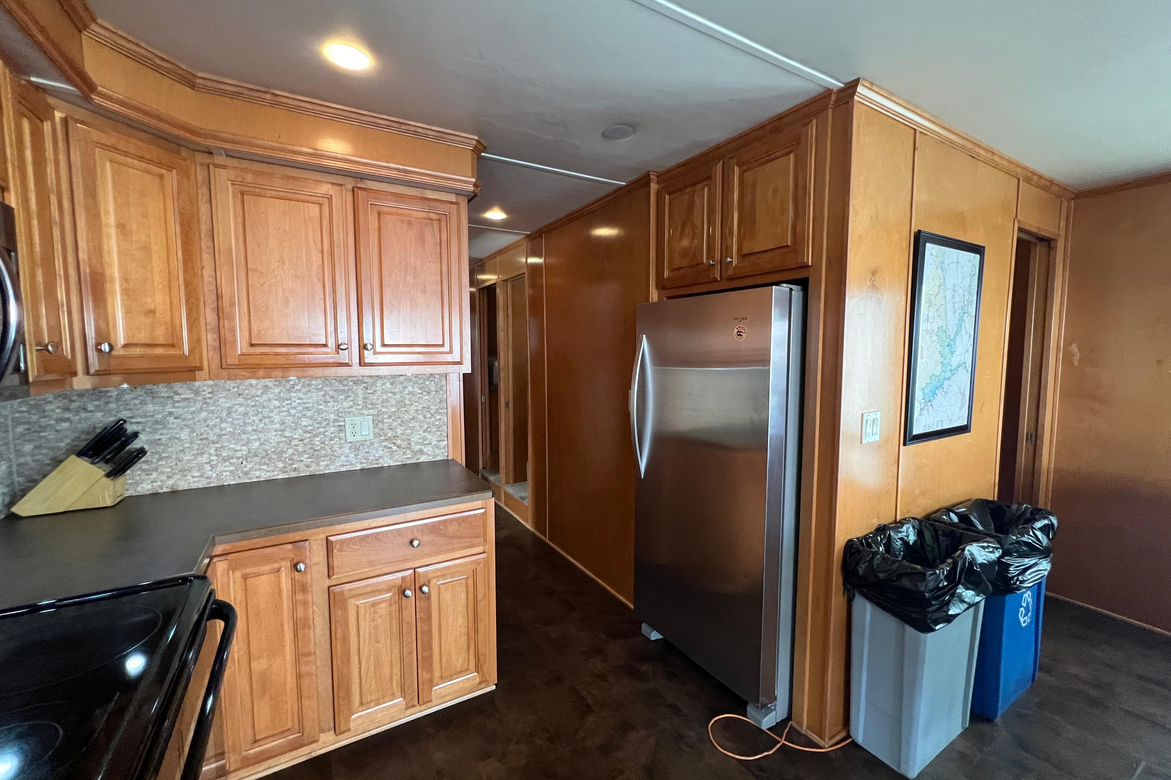 Kitchen interior of 2013 Destination Yacht Lotta Yachta with wooden cabinets and stainless steel fridge.