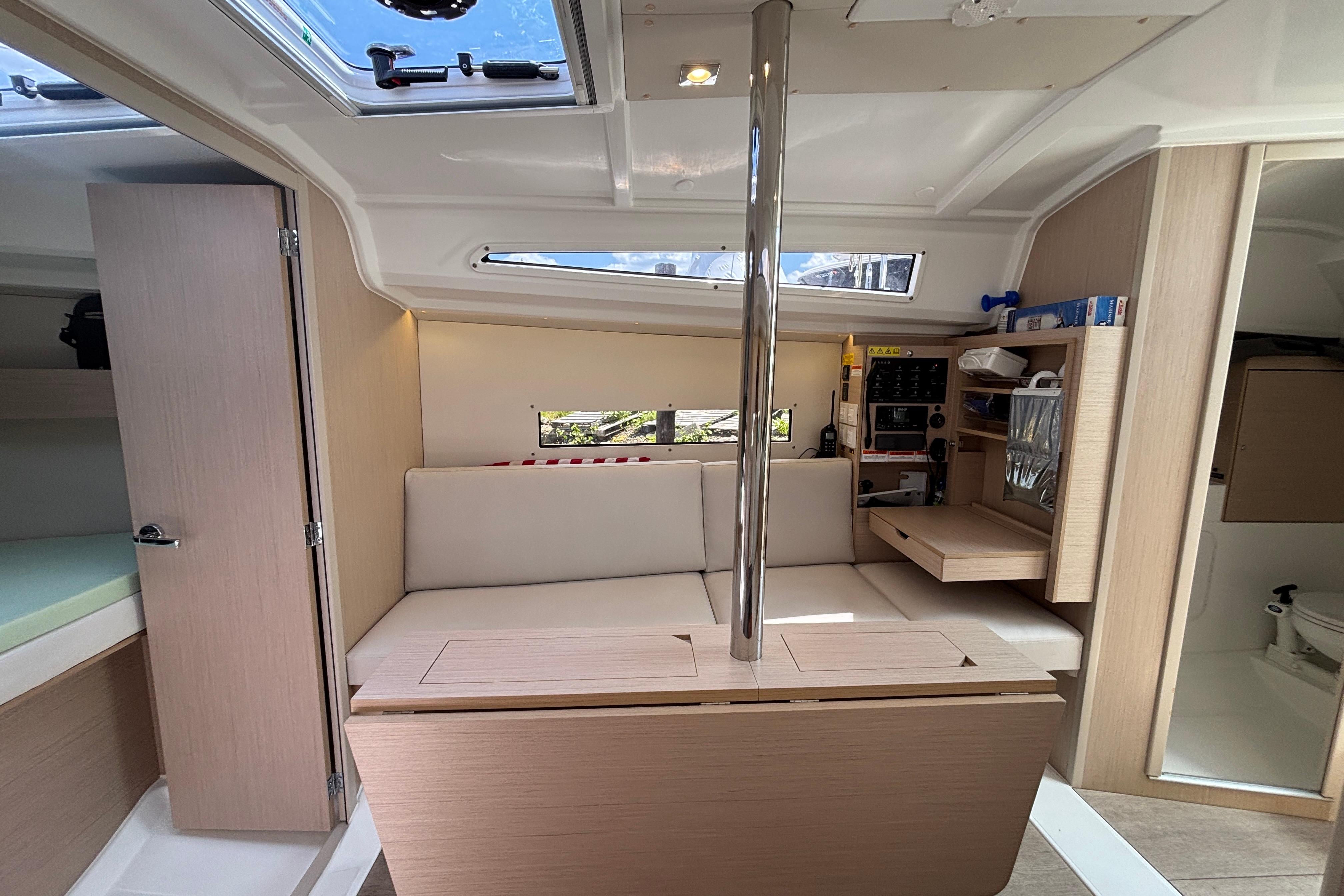 Interior of 2021 Beneteau Oceanis 30.1 yacht, featuring modern seating and navigation equipment.