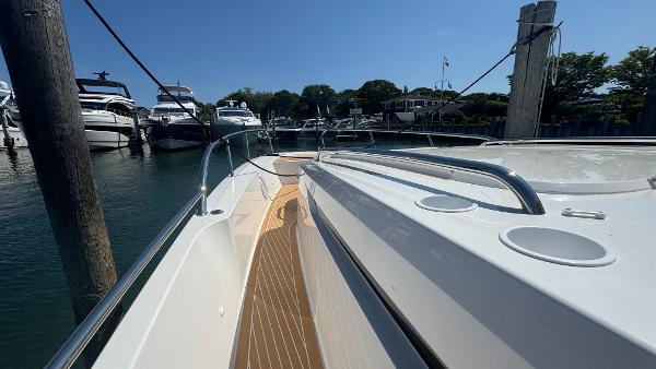 2025 Nimbus T11 boat docked in a marina under clear blue skies.