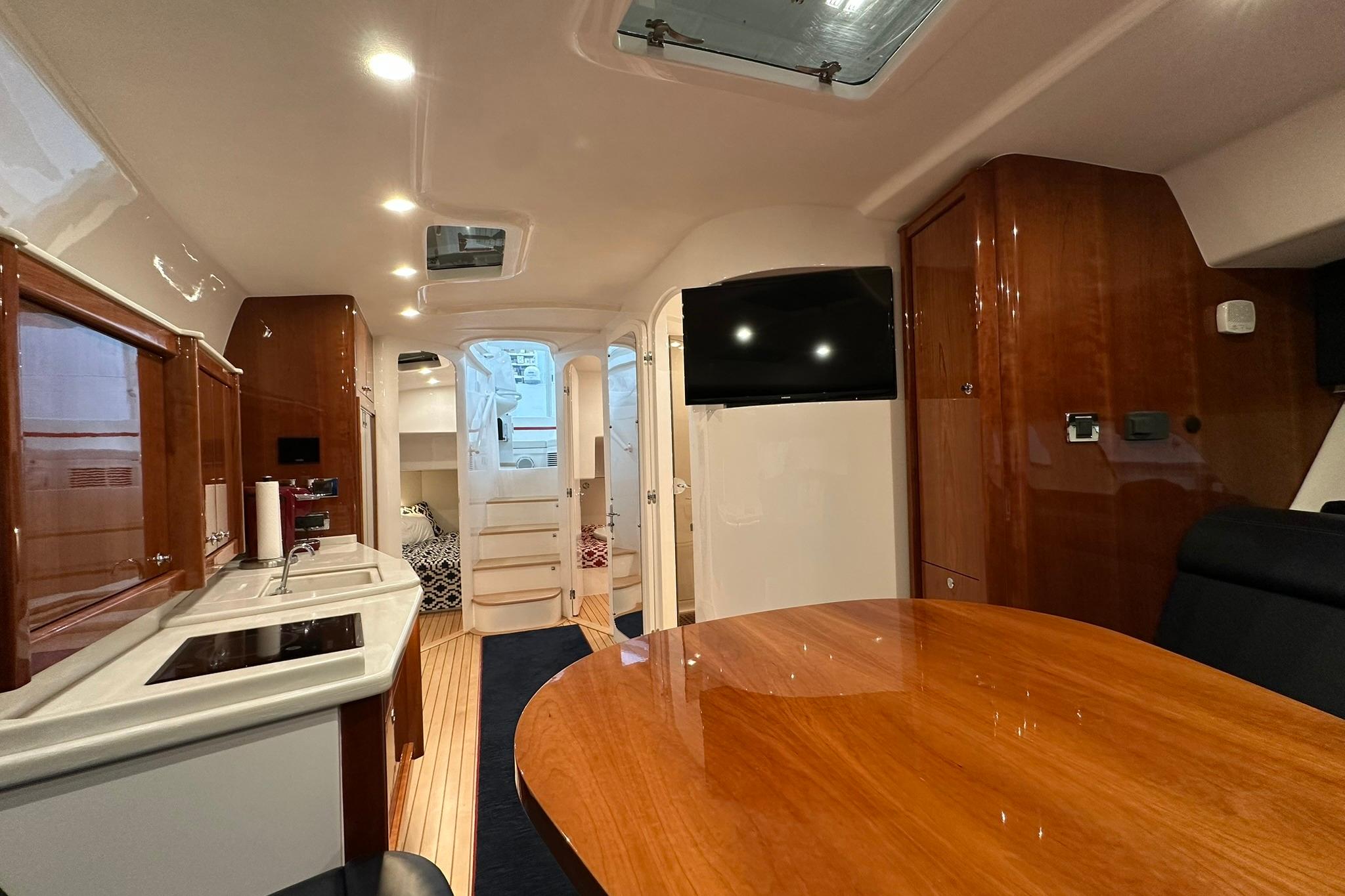 Luxurious interior of 2020 Intrepid 475 Sport Yacht with wood finishes and modern amenities.