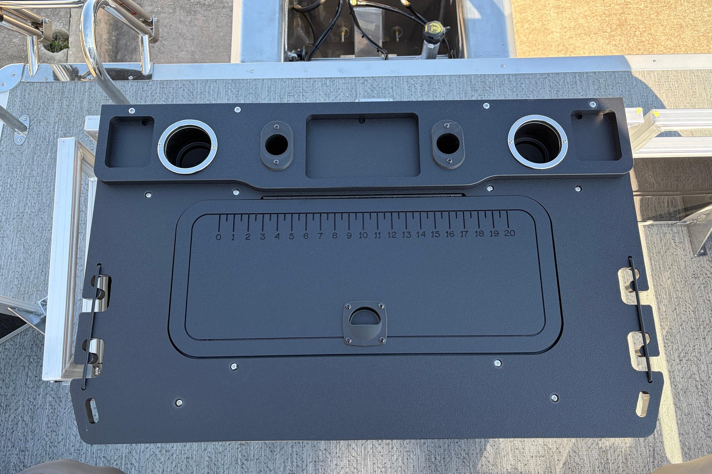 2026 Sun Tracker Fishin' Barge 22 XP3 fishing station with cup holders and measuring scale.