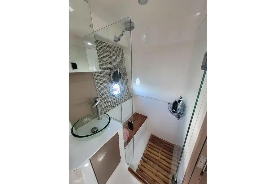 Modern bathroom in 2024 Hanover 387 with glass sink and shower.