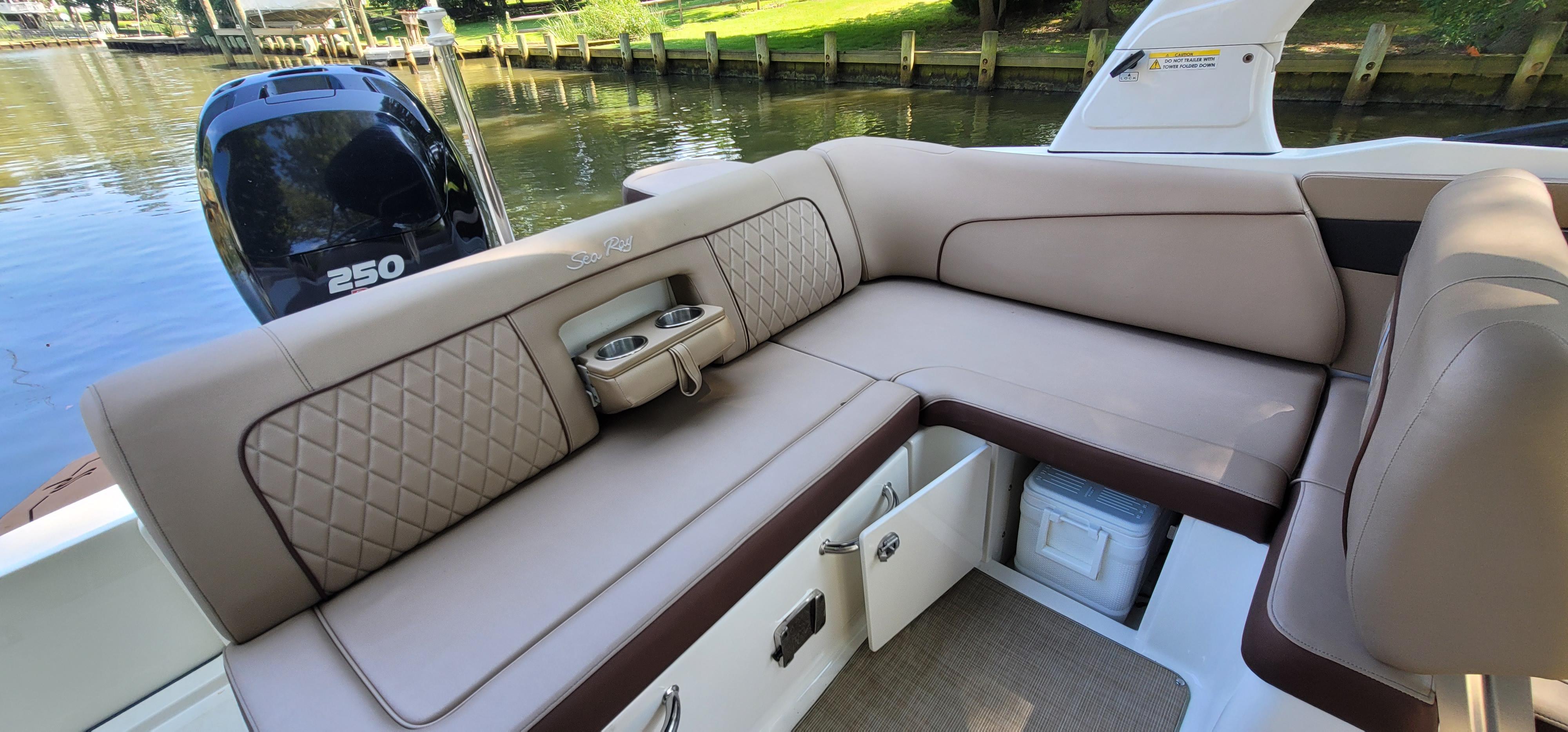 Luxurious seating on 2017 Sea Ray SDX 240 Outboard boat, featuring quilted upholstery and storage compartments.